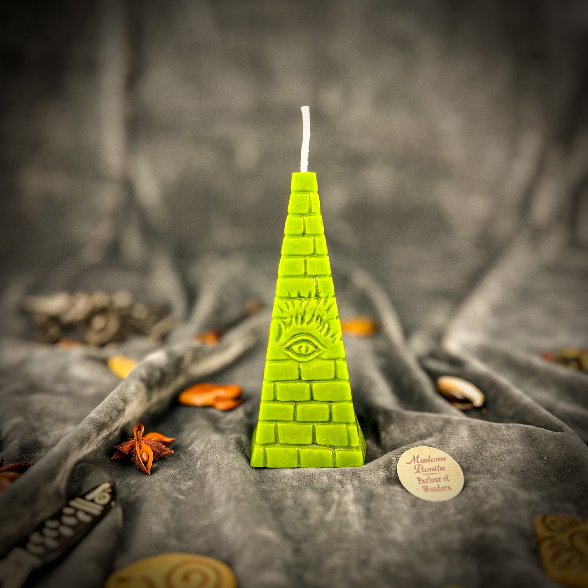 Green beeswax all-seeing eye pyramid spell candle by Parlour of Wonders, symbolizing abundance, prosperity, and intuition.