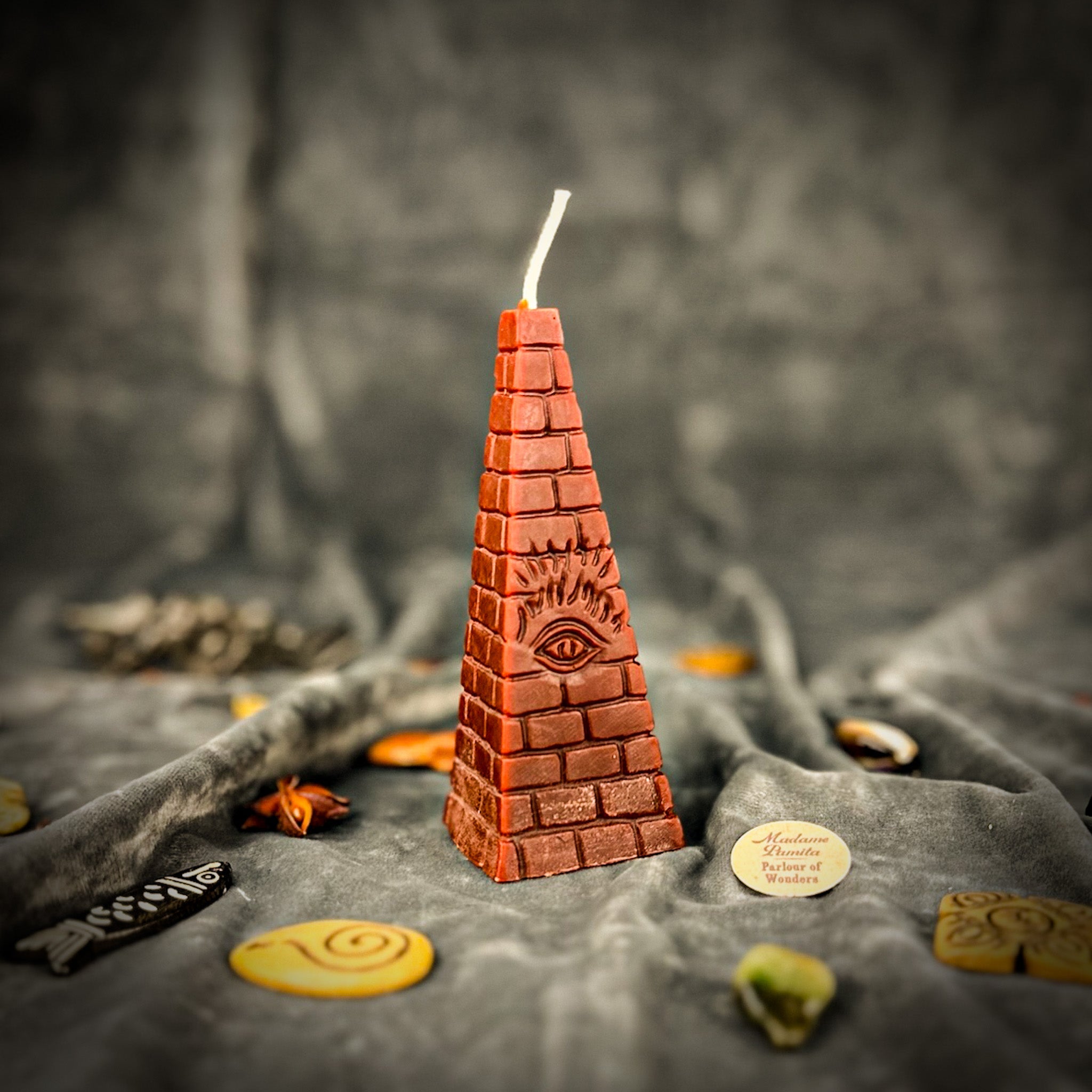 Green beeswax candle with an all-seeing eye pyramid design, symbolizing abundance, prosperity, and intuition.