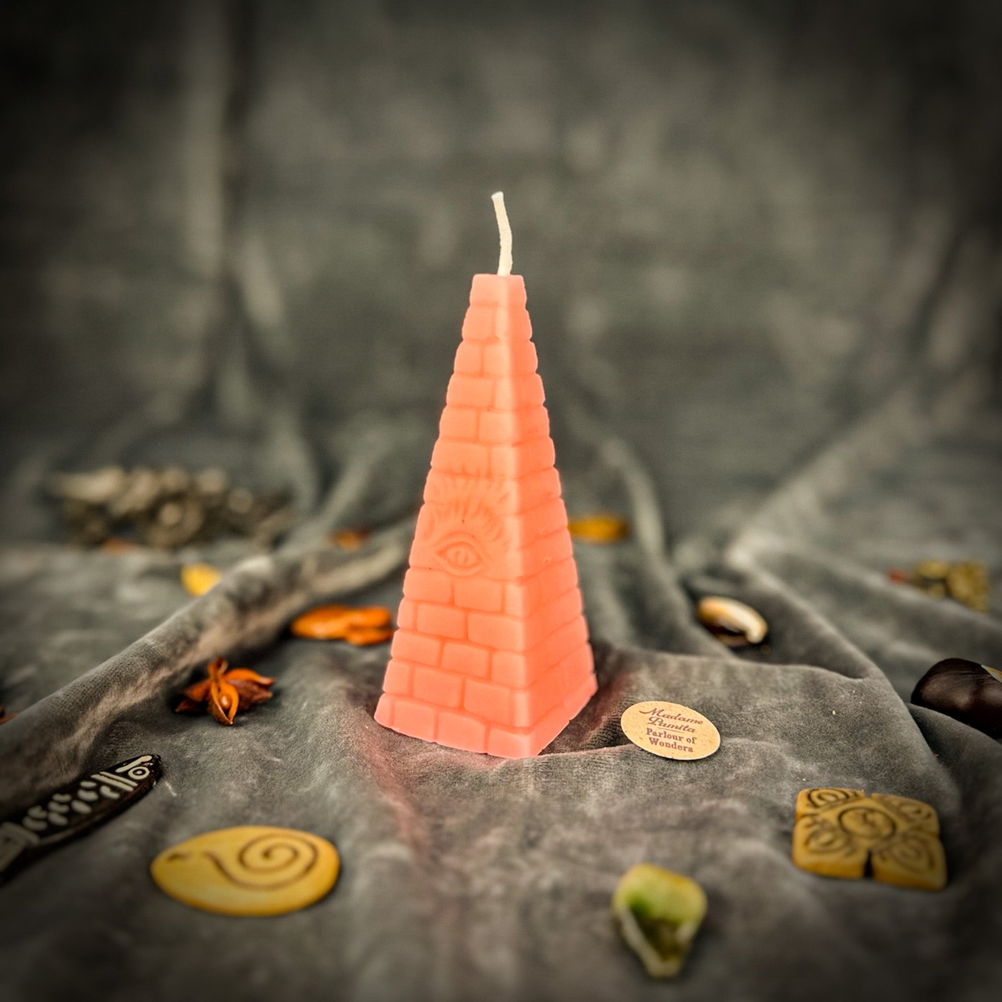 Green beeswax candle with an all-seeing eye pyramid design, symbolizing abundance, prosperity, and intuition.