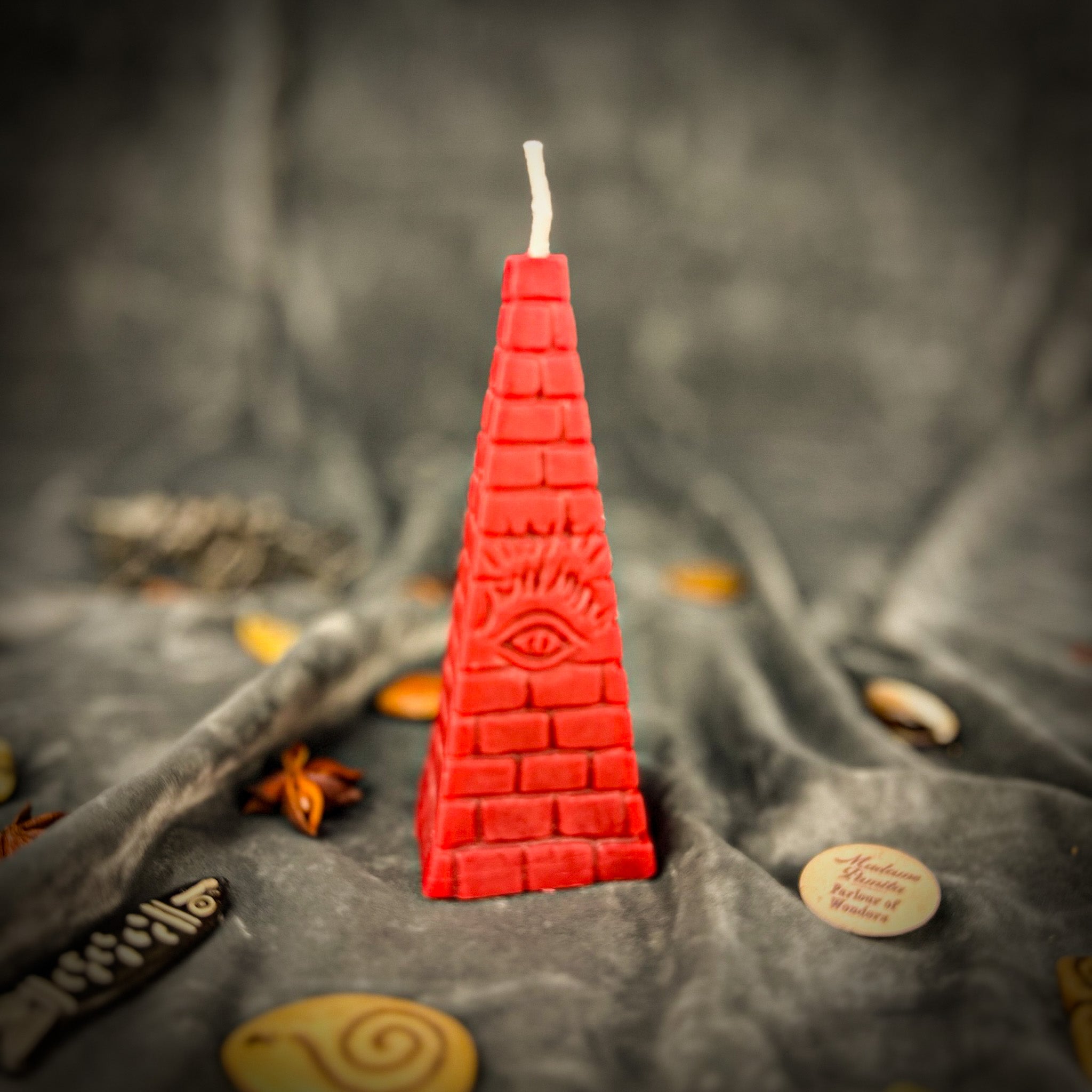 Green beeswax candle with an all-seeing eye pyramid design, symbolizing abundance, prosperity, and intuition.