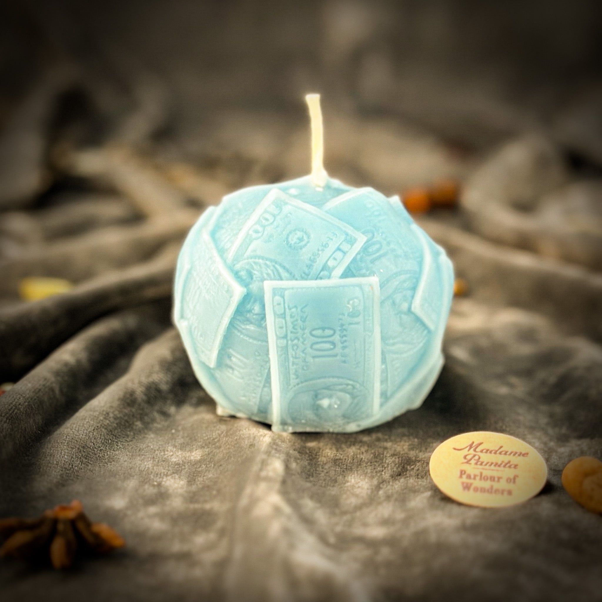 Green beeswax candle by Parlour of Wonders featuring a rolling in dough design, symbolizing wealth and abundance.