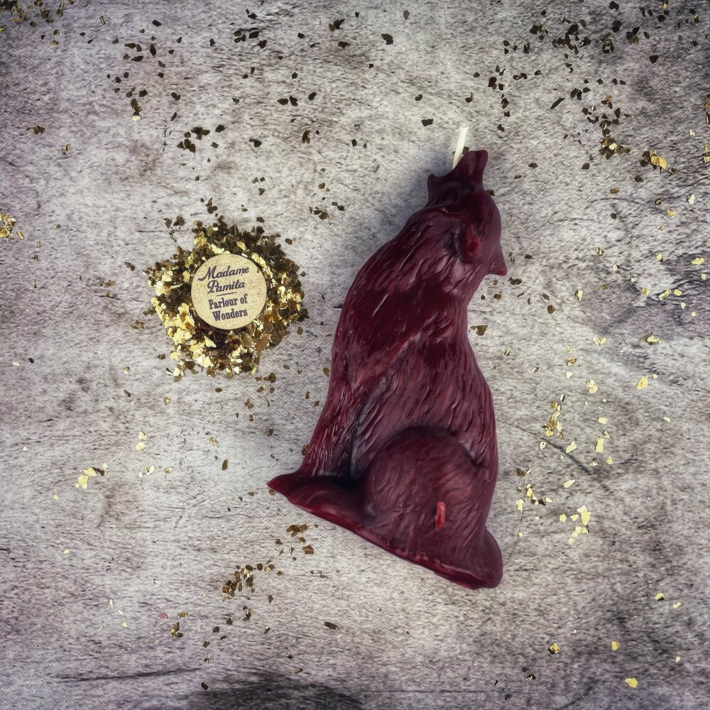 Beeswax Howling Wolf Spell Candle by Parlour of Wonders, orange candle with wolf design for courage and authentic voice magic.