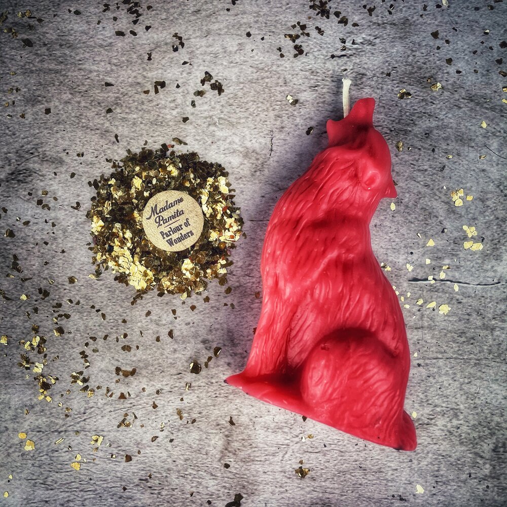 Beeswax Howling Wolf spell candle from Parlour of Wonders, orange wax with wolf design, symbolizing courage and authentic voice magic.