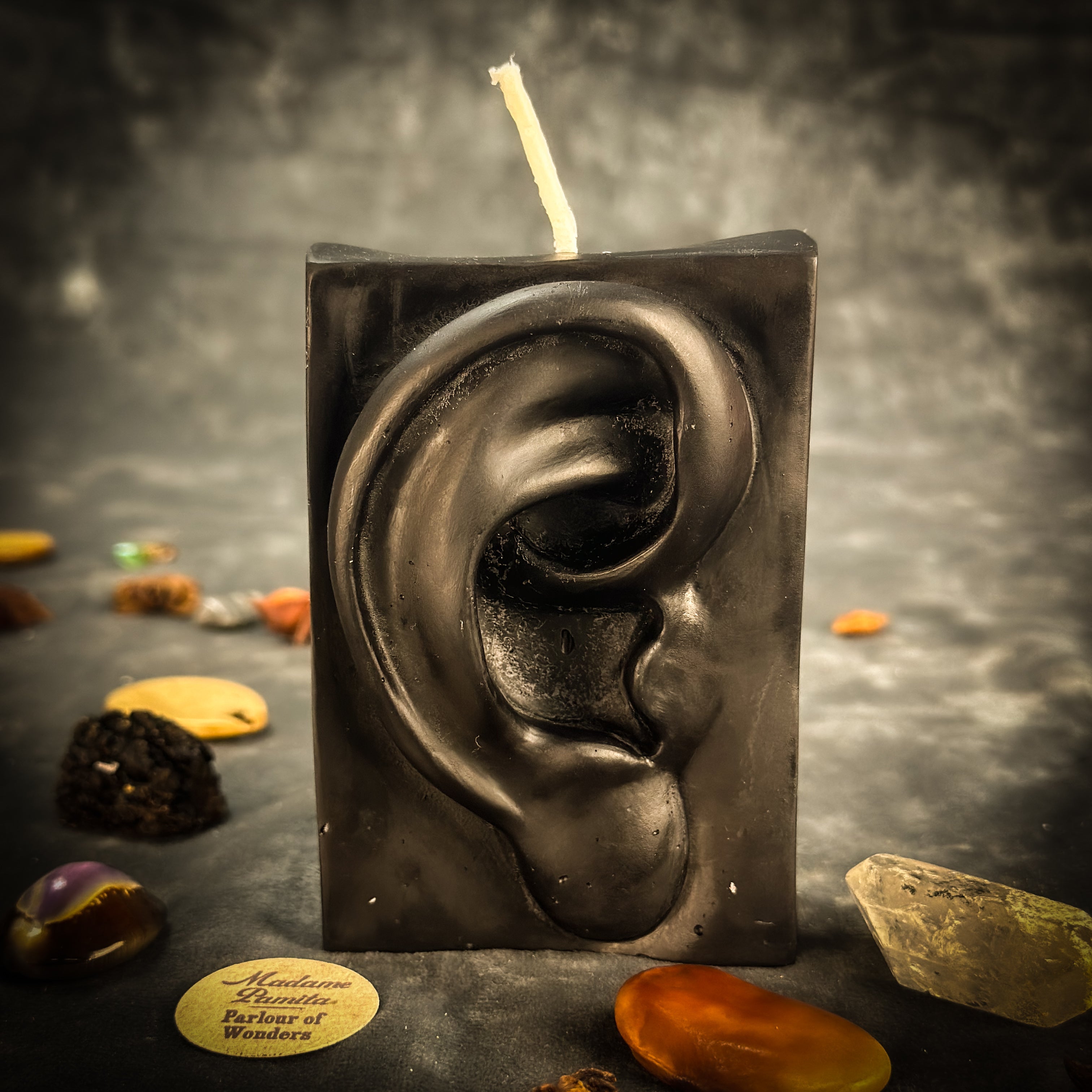 Beeswax Ex-Voto Ear Spell Candle by Parlour of Wonders for healing, clairaudience, and being heard, with orange wax and healing symbols.