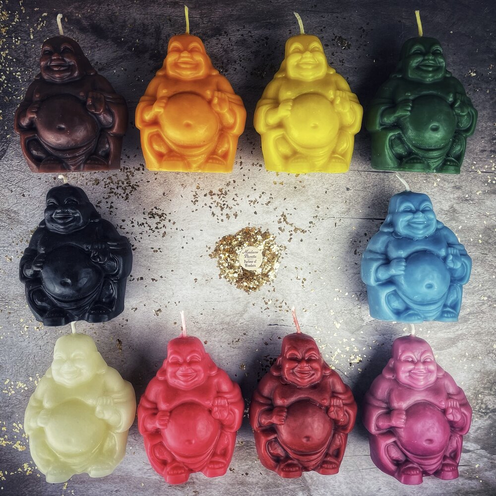 Beeswax Laughing Buddha spell candle by Parlour of Wonders, orange wax with intricate designs for wealth, luck, and prosperity magic.