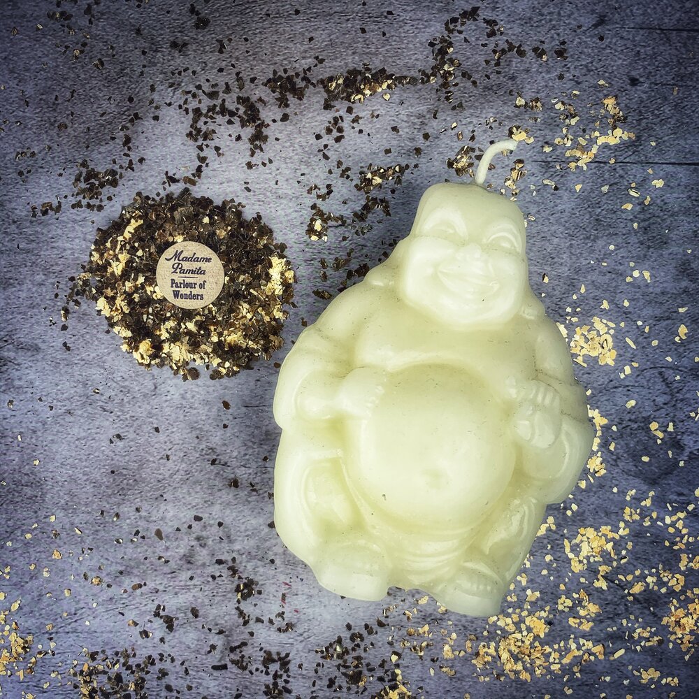 Beeswax Laughing Buddha spell candle by Parlour of Wonders with orange wax, symbolizing wealth, luck, and prosperity magic.