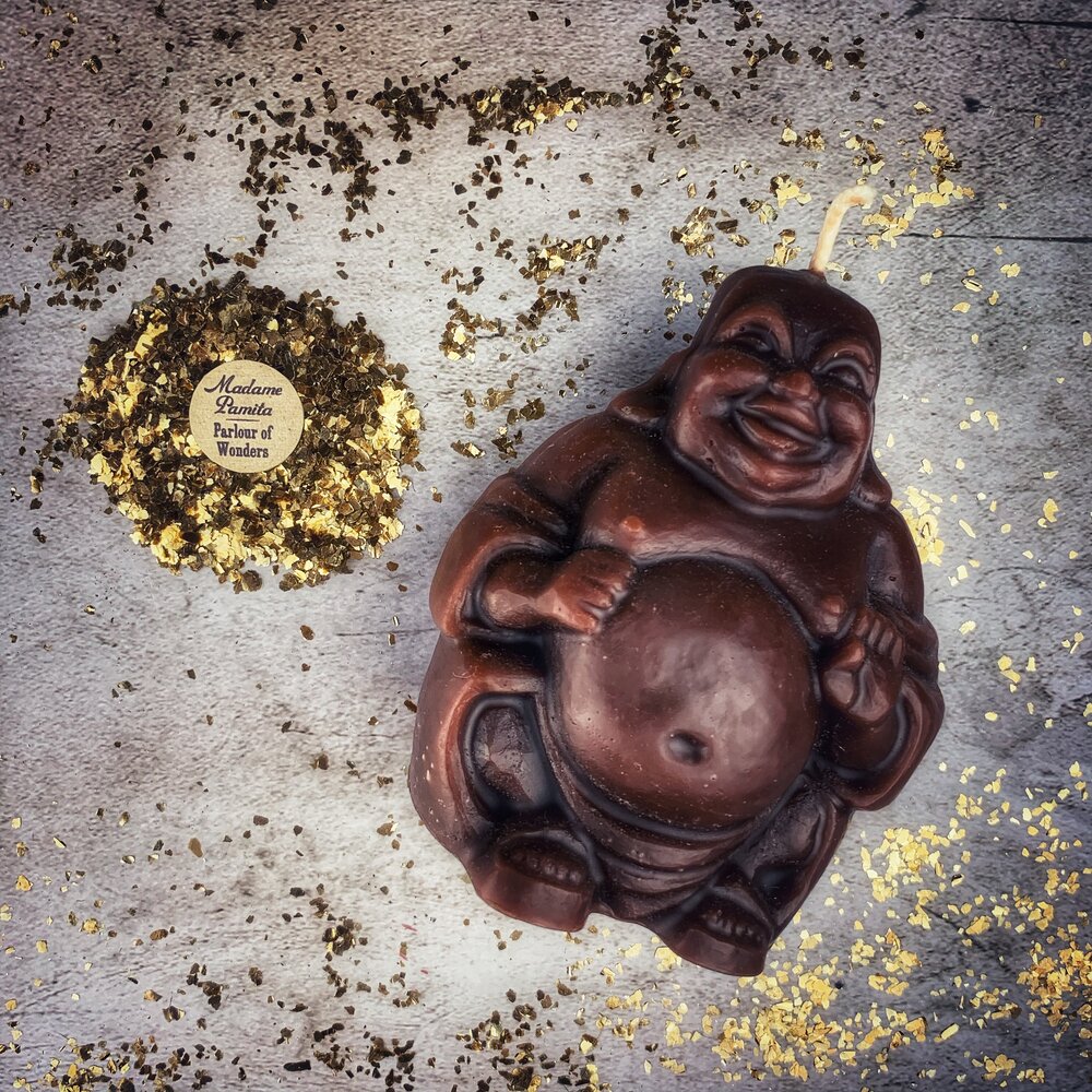 Beeswax Laughing Buddha spell candle by Parlour of Wonders, orange beeswax candle for wealth, luck, and prosperity magic.