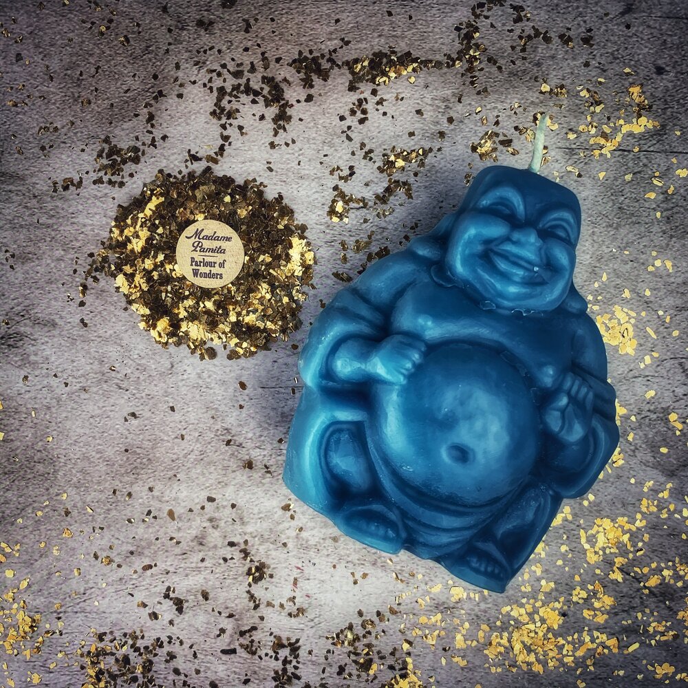 Beeswax Laughing Buddha spell candle by Parlour of Wonders, orange beeswax candle for wealth, luck, and prosperity magic.