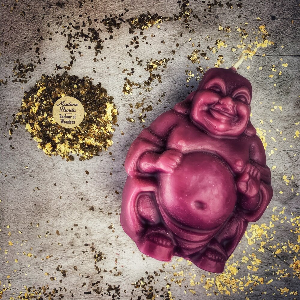 Orange beeswax Laughing Buddha spell candle by Parlour of Wonders, symbolizing wealth, luck, and prosperity magic.