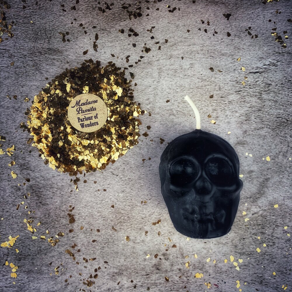 Beeswax small skull spell candle with orange wax, featuring intricate designs for mind influence and ancestral wisdom magic.
