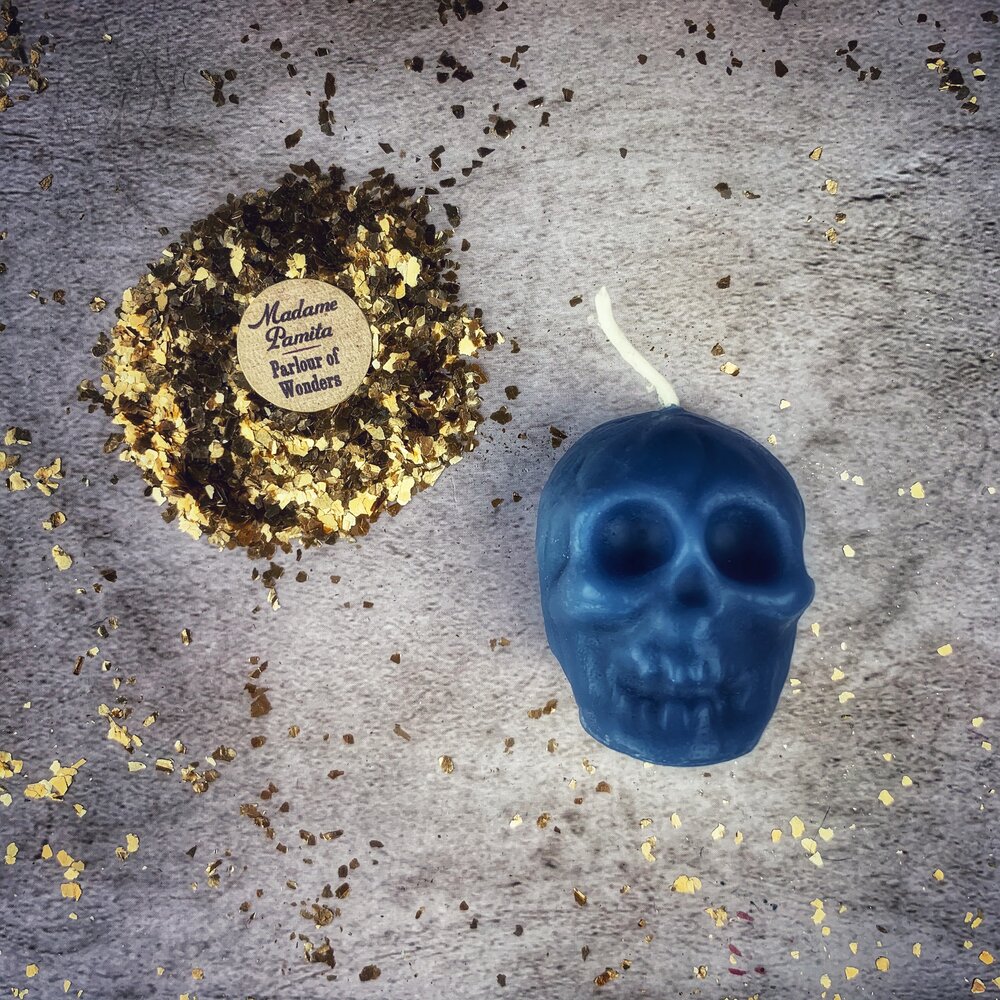 Small beeswax skull spell candle by Parlour of Wonders with orange wax, designed for mind influence and ancestral wisdom magic.
