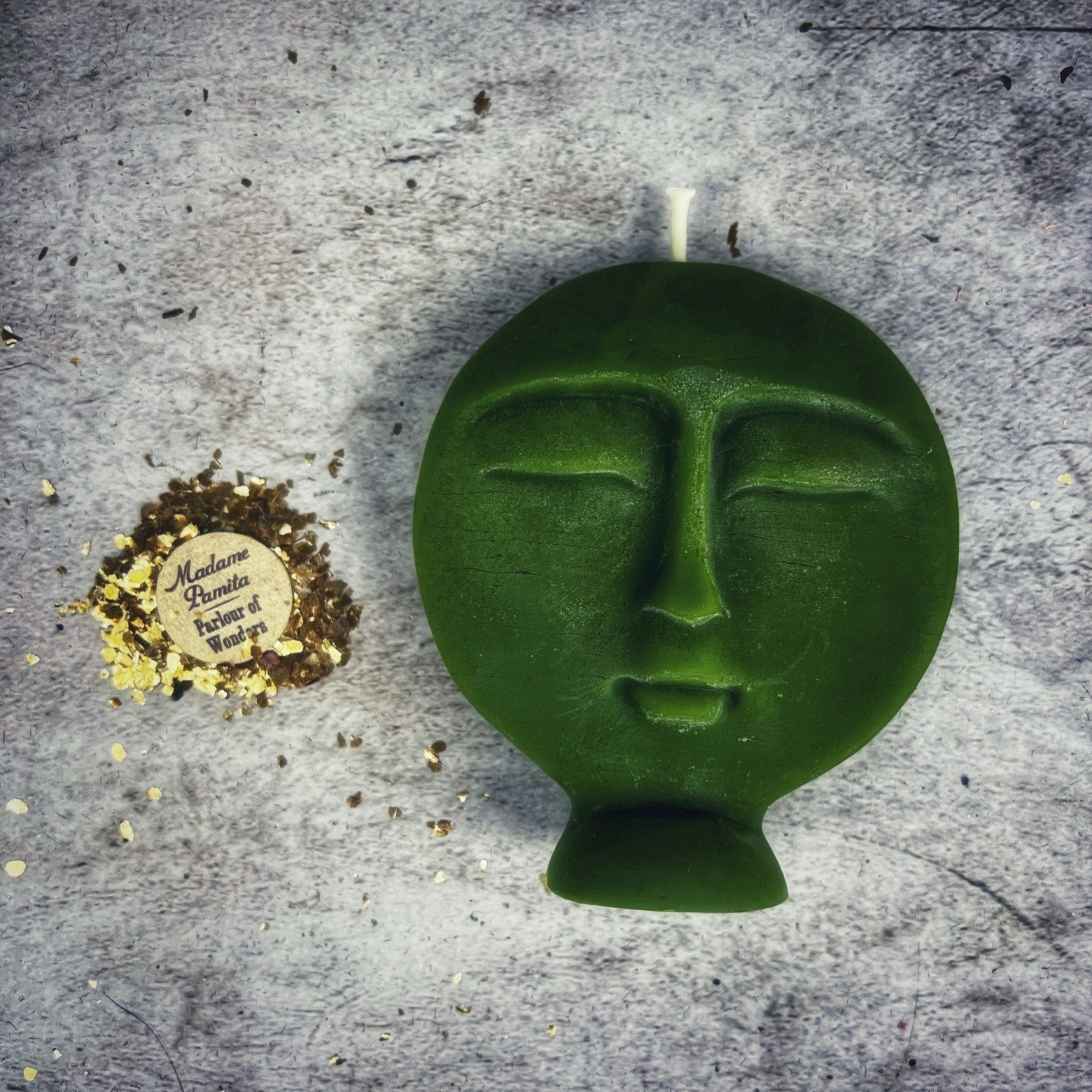 Pink beeswax candle from Parlour of Wonders featuring an ancestor spirit design for guidance and protection magic.