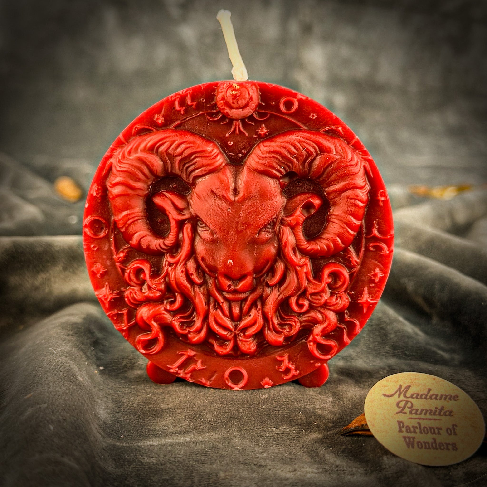 Pink beeswax Aries Ram zodiac spell candle with engraved symbols, representing courage, passion, and victory for astrological rituals.