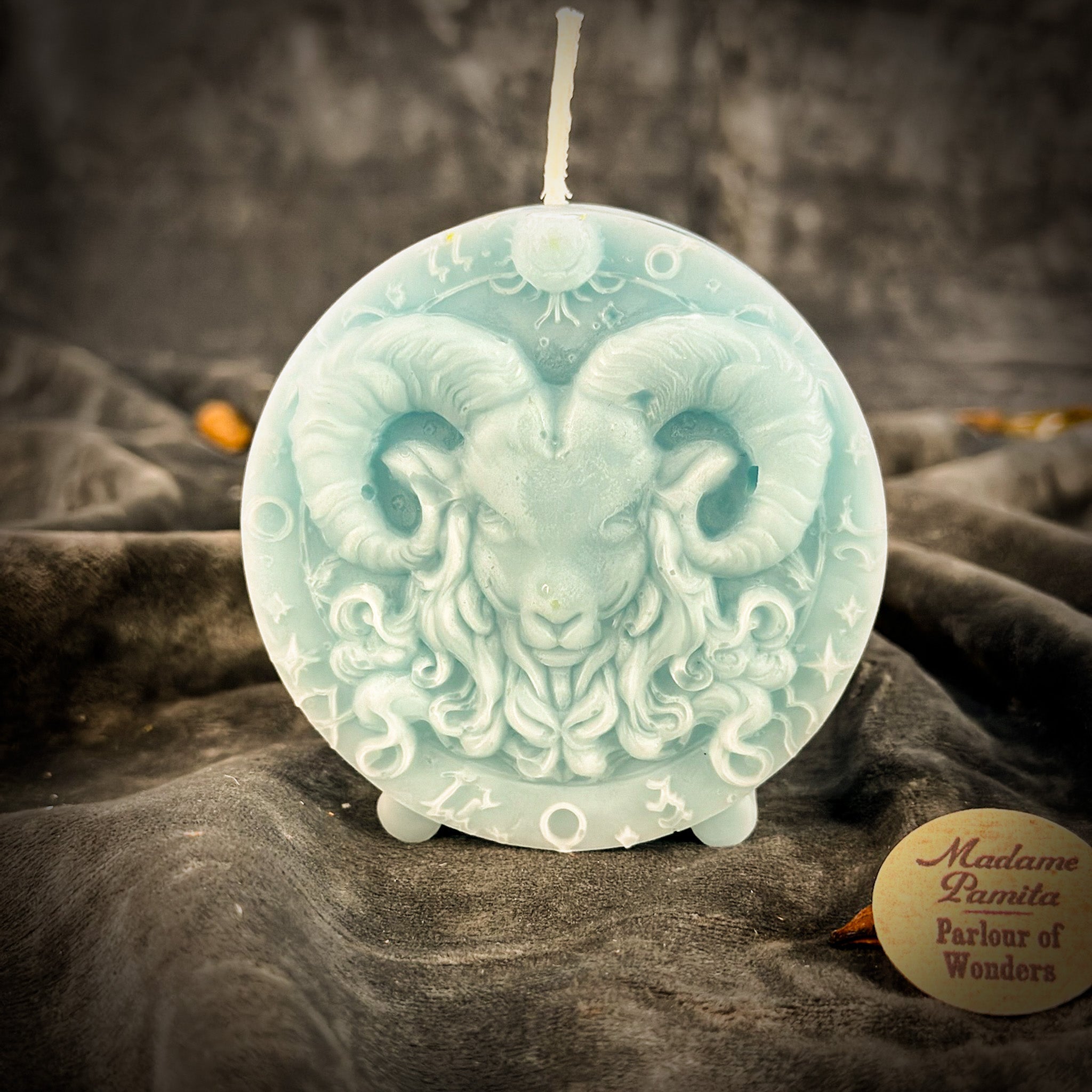 Pink beeswax Aries Ram zodiac spell candle by Parlour of Wonders, featuring detailed zodiac symbol for courage and passion.