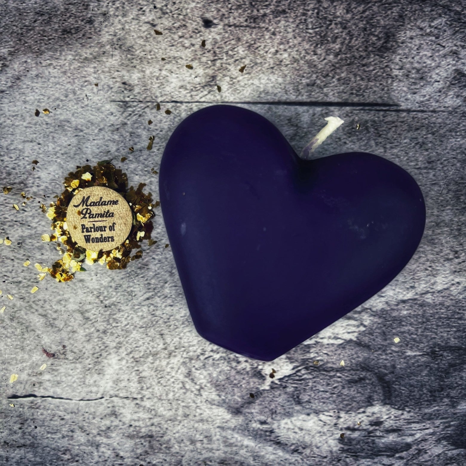 Pink beeswax candle with a carved heart, designed for love reconciliation and emotional healing magic by Parlour of Wonders.