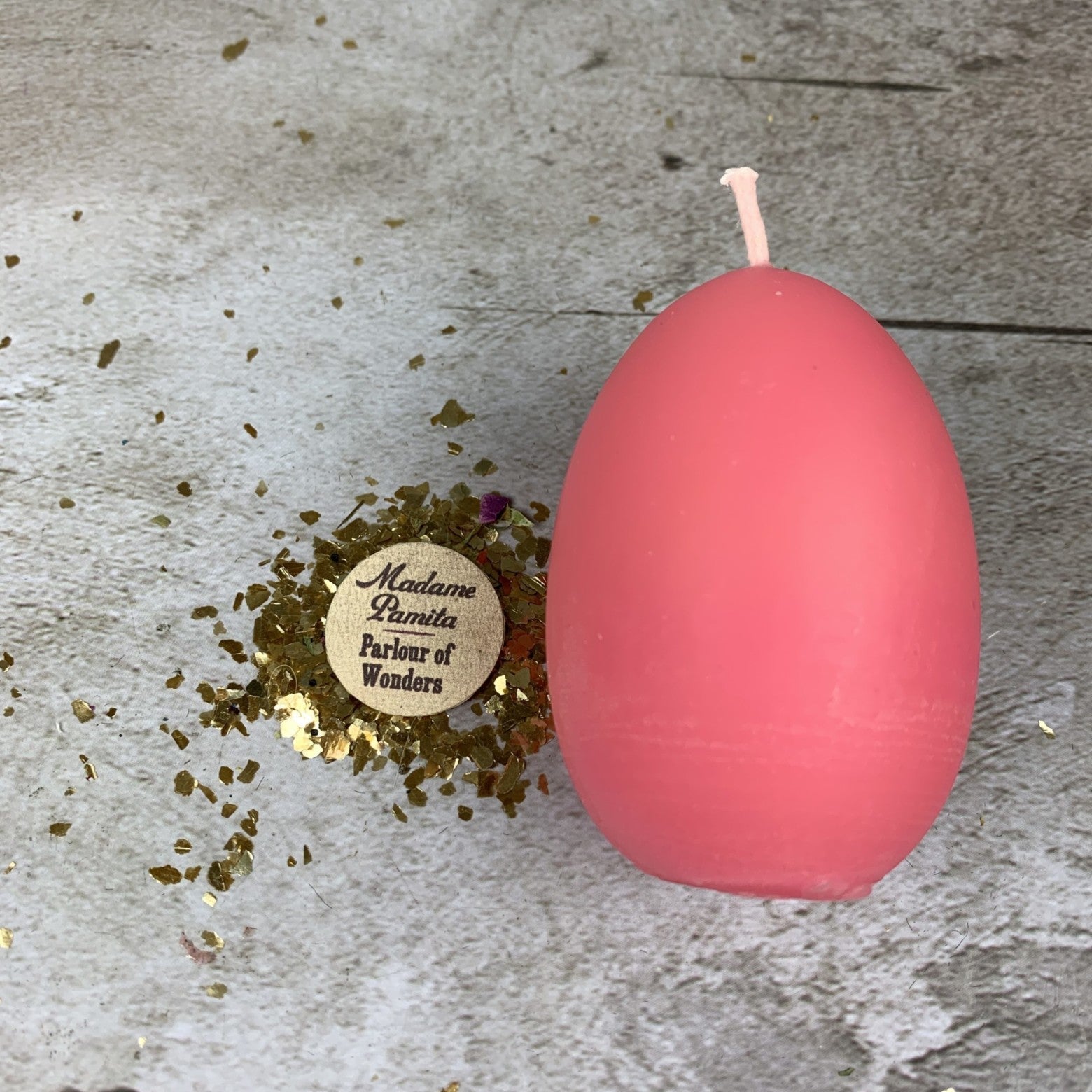 Pink beeswax egg talisman spell candle by Parlour of Wonders, representing new beginnings and fertility magic.