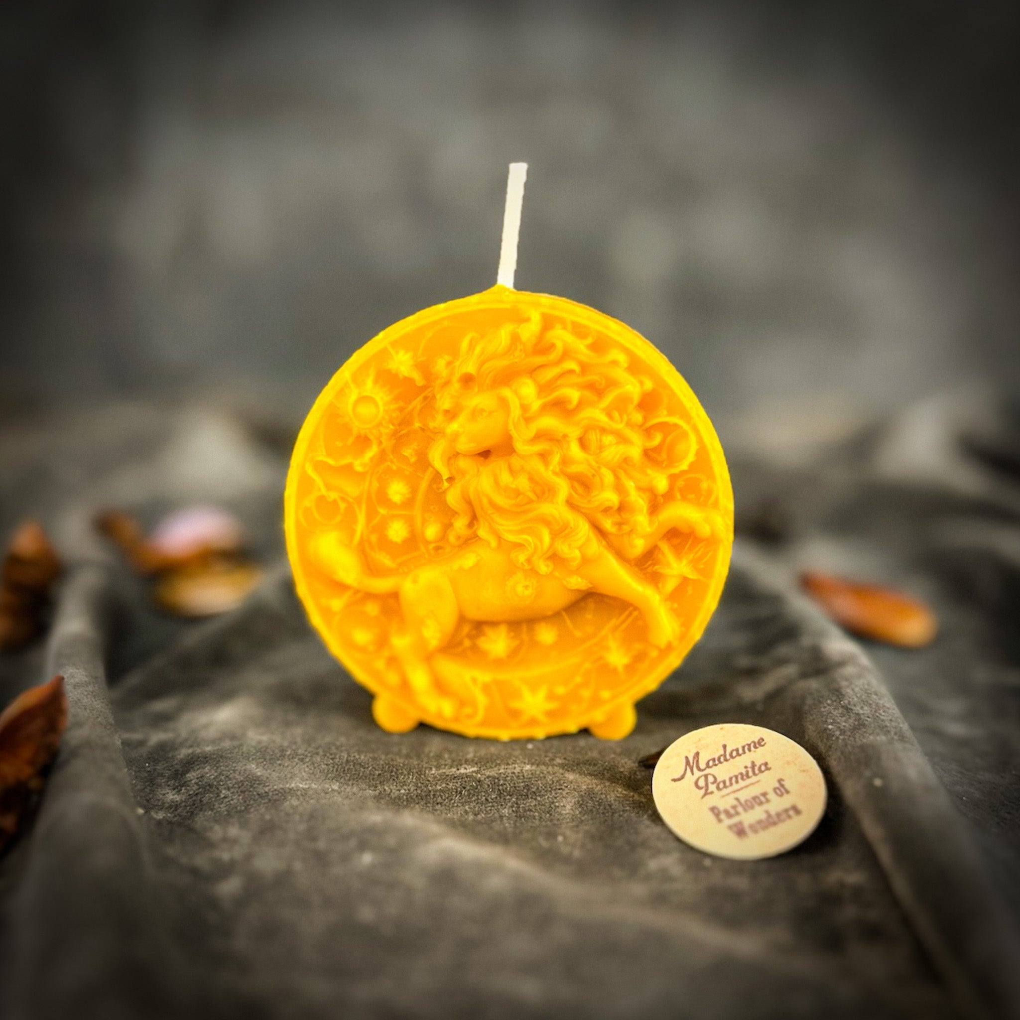 Pink beeswax Leo Lion zodiac spell candle by Parlour of Wonders with intricate lion design for creativity, confidence, and leadership.