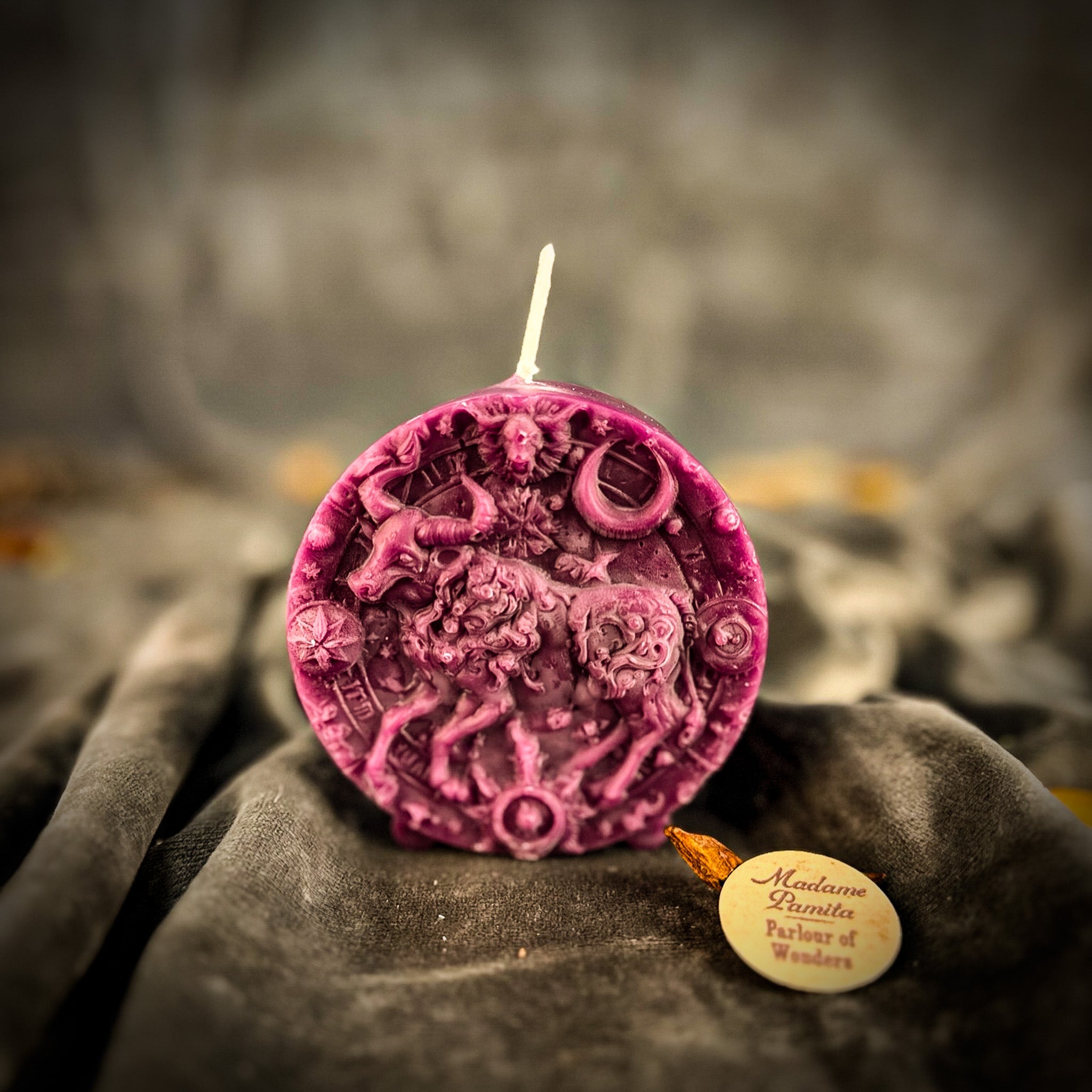 Pink beeswax Taurus Bull zodiac spell candle by Parlour of Wonders, symbolizing abundance, stability, and sensuality.