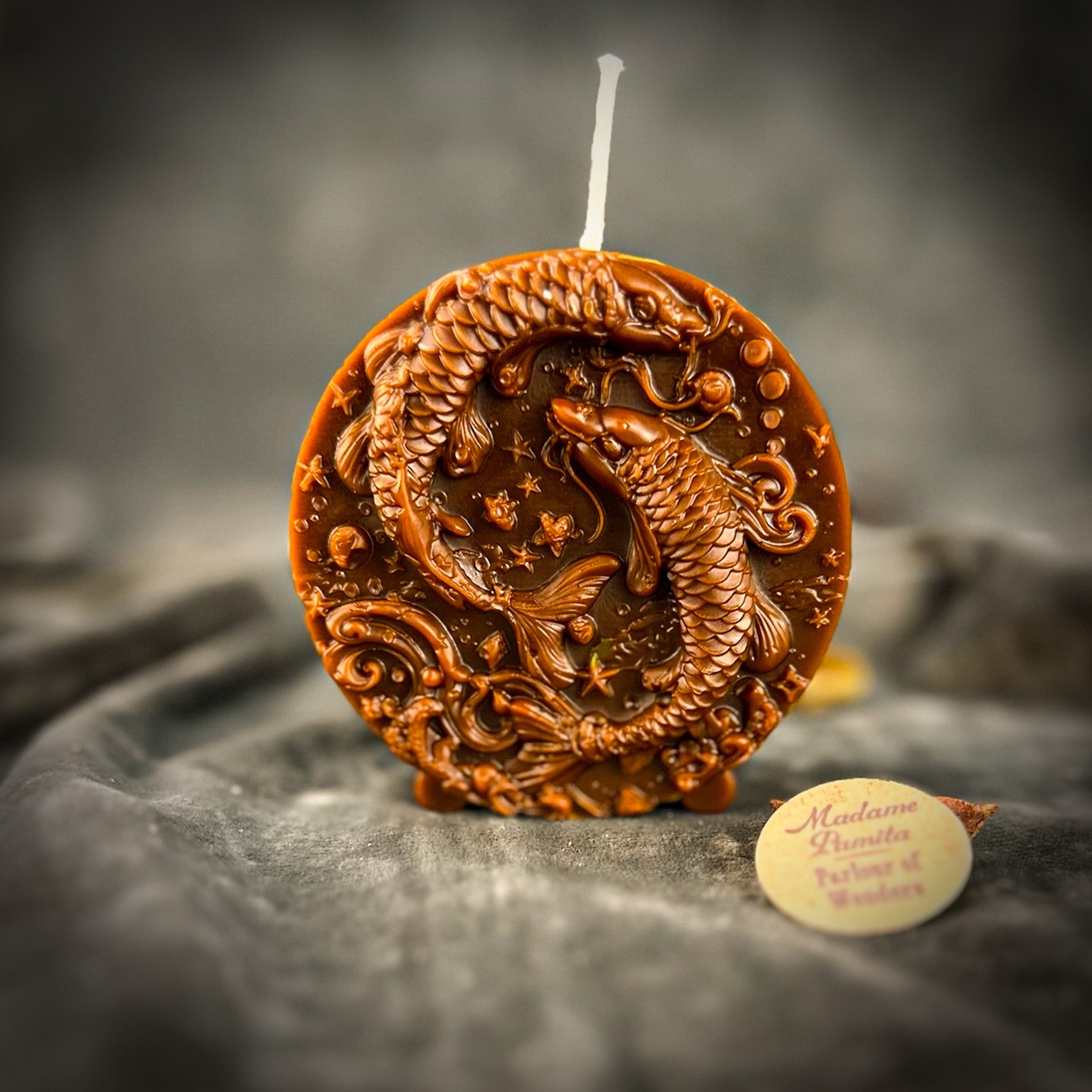 Purple beeswax Pisces fish zodiac spell candle with intricate fish design, representing intuition, compassion, and dreams.