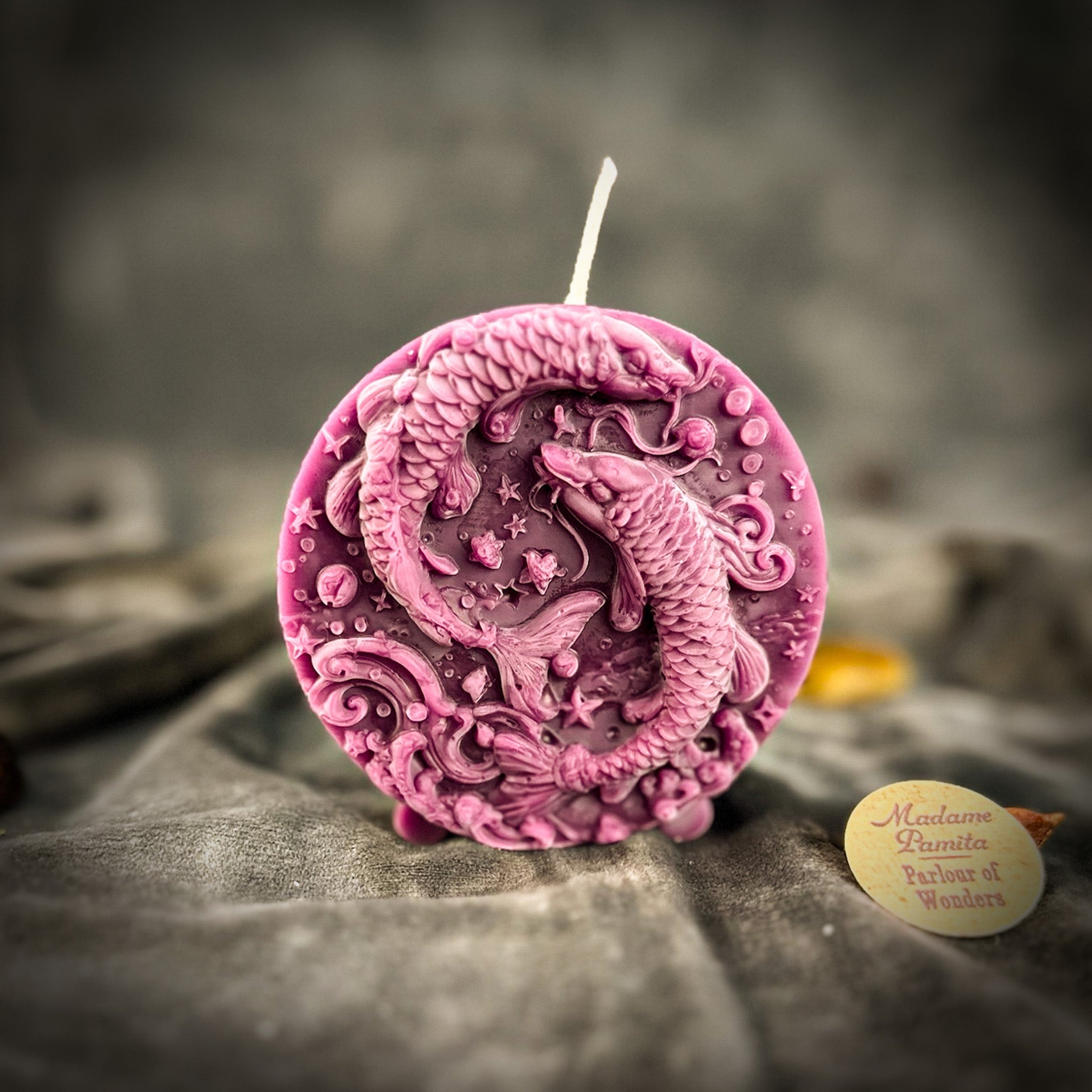 Purple beeswax Pisces Fish zodiac spell candle by Parlour of Wonders, featuring intricate fish design for intuition and dreams.