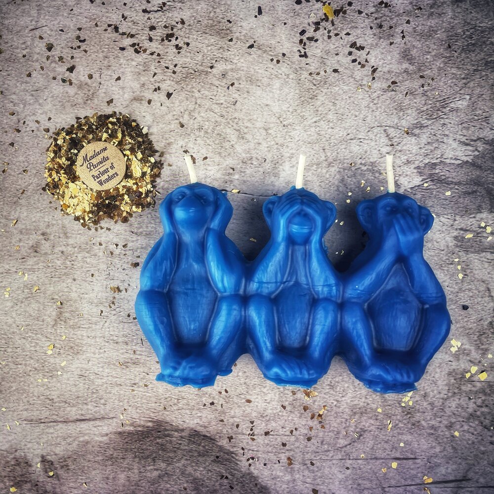 Red beeswax candle featuring three wise monkeys design, used for stopping jealousy, gossip, and silencing enemies.