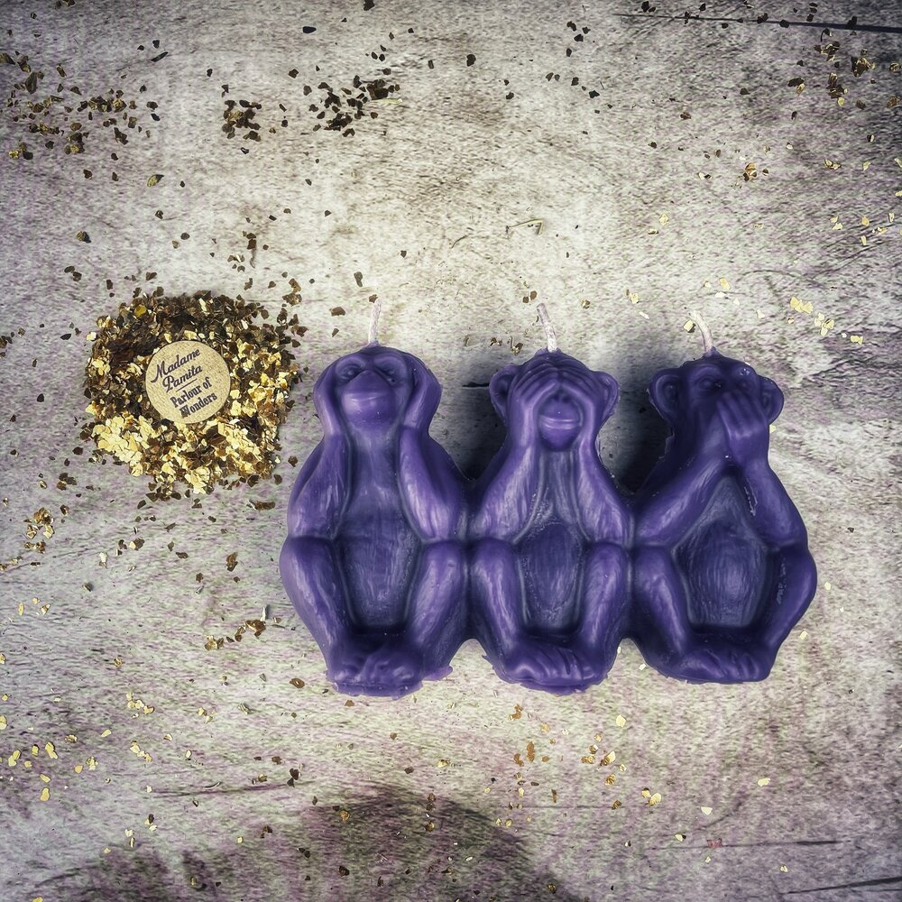 Red beeswax candle featuring three wise monkeys design, used for spellwork to stop jealousy, gossip, and silence enemies.