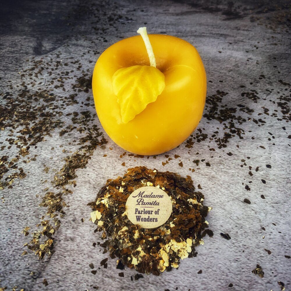 Red beeswax Apple of Avalon spell candle by Parlour of Wonders, featuring intricate details for love and abundance magic.