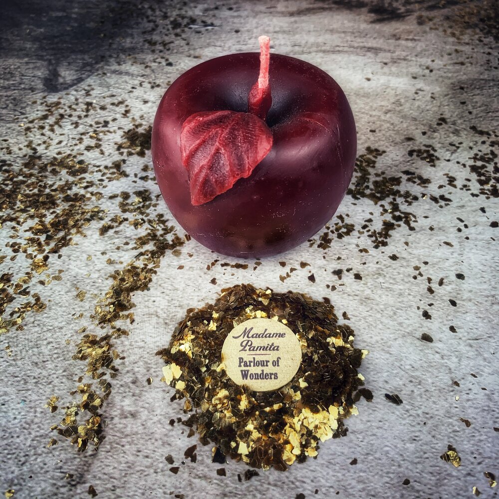 Red beeswax candle labeled "Apple of Avalon" by Parlour of Wonders, featuring a passion and abundance magic design.