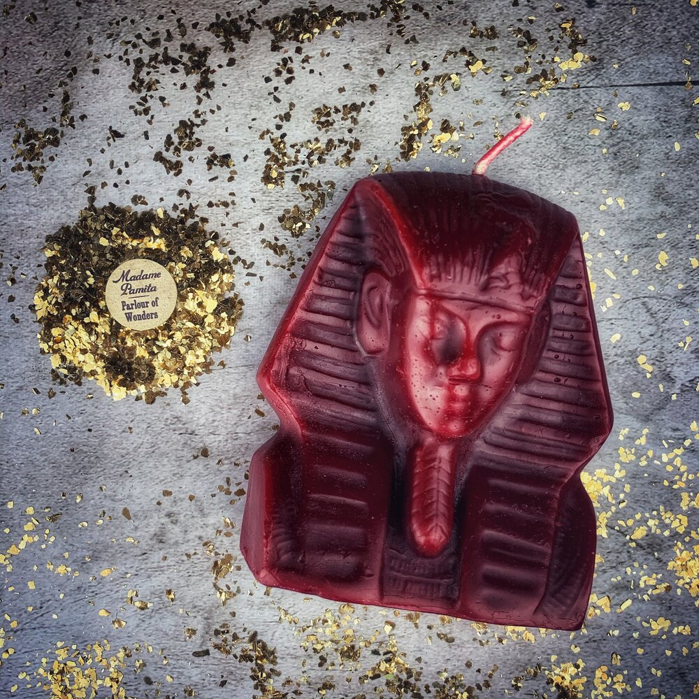 Red beeswax Egyptian King Spell Candle by Parlour of Wonders, featuring intricate hieroglyphic designs for power and magnetism magic.