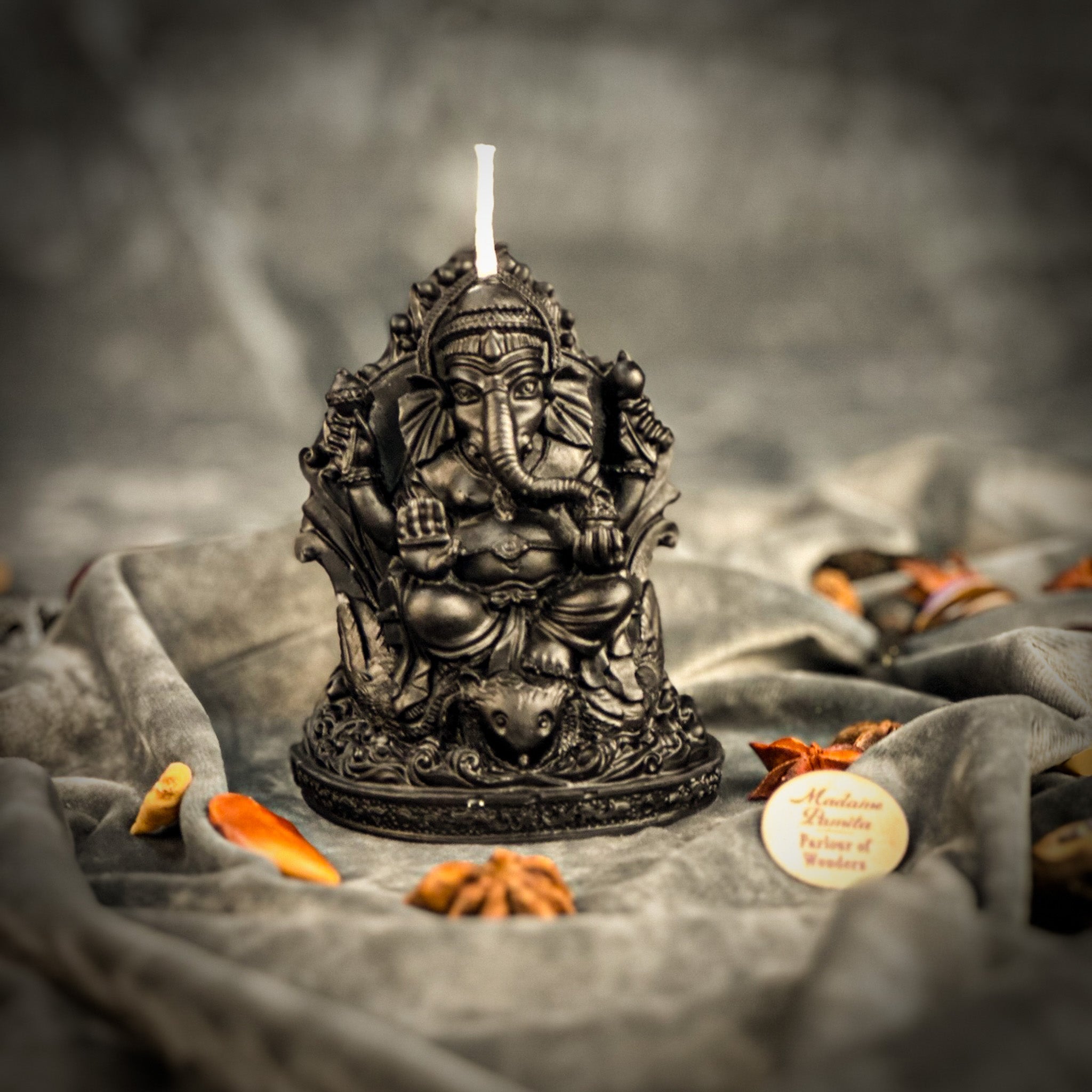 Red beeswax Ganesha spell candle from Parlour of Wonders, featuring intricate Ganesha design for obstacle removal and success magic.