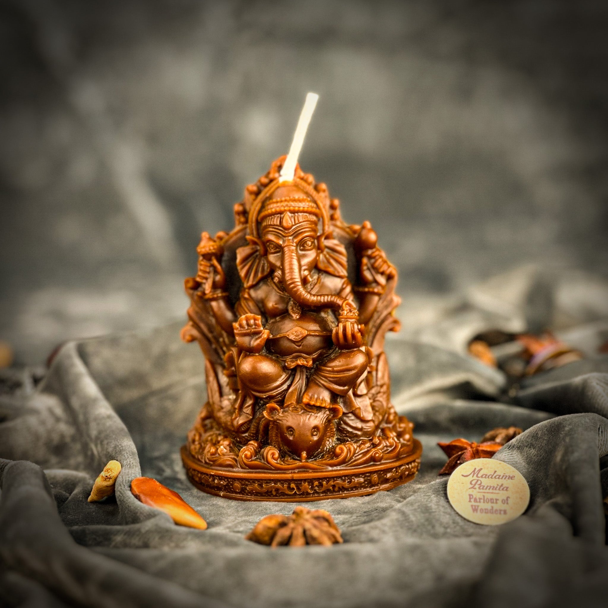 Red beeswax Ganesha spell candle from Parlour of Wonders, featuring intricate Ganesha design for obstacle removal and success magic.