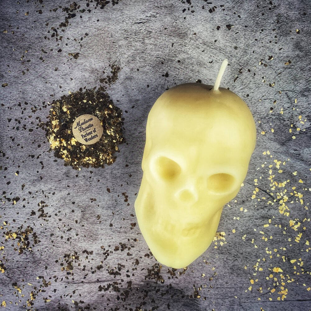 Large red beeswax skull spell candle with intricate details, used for mind influence and ancestral wisdom magic.