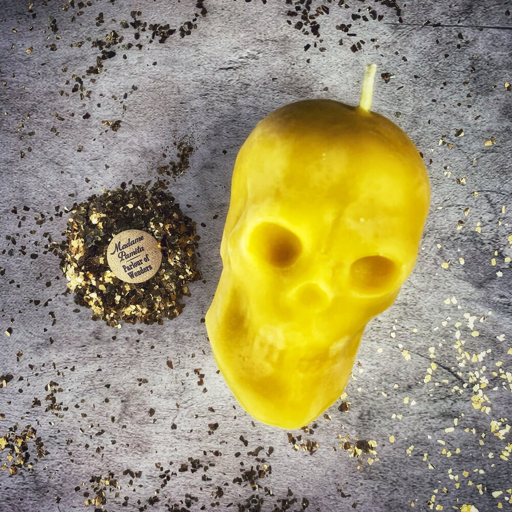 Large red beeswax skull candle from Parlour of Wonders, featuring intricate carvings for mind influence and ancestral wisdom magic.