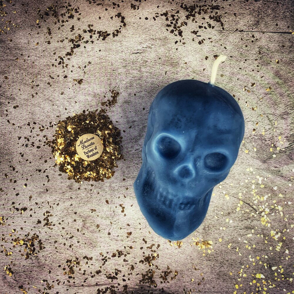 Large red beeswax skull candle with detailed features, designed for mind influence and ancestral wisdom magic by Parlour of Wonders.