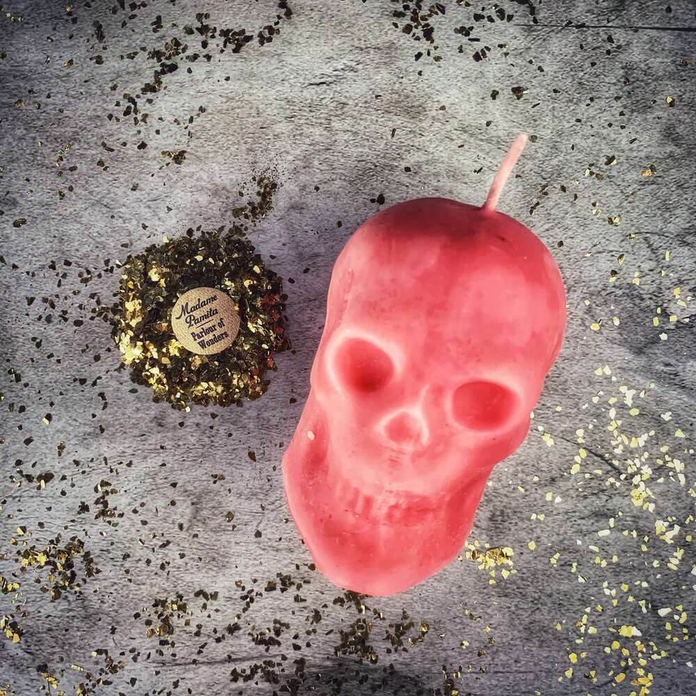 Large red beeswax skull candle by Parlour of Wonders, featuring intricate carvings for mind influence and ancestral wisdom magic.