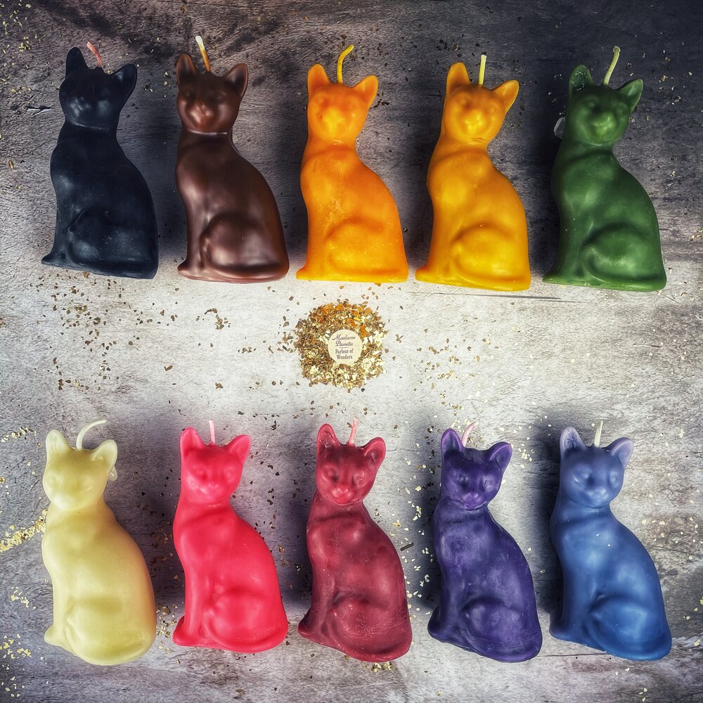 Red beeswax lucky cat spell candle by Parlour of Wonders for fast action and manifestation magic.