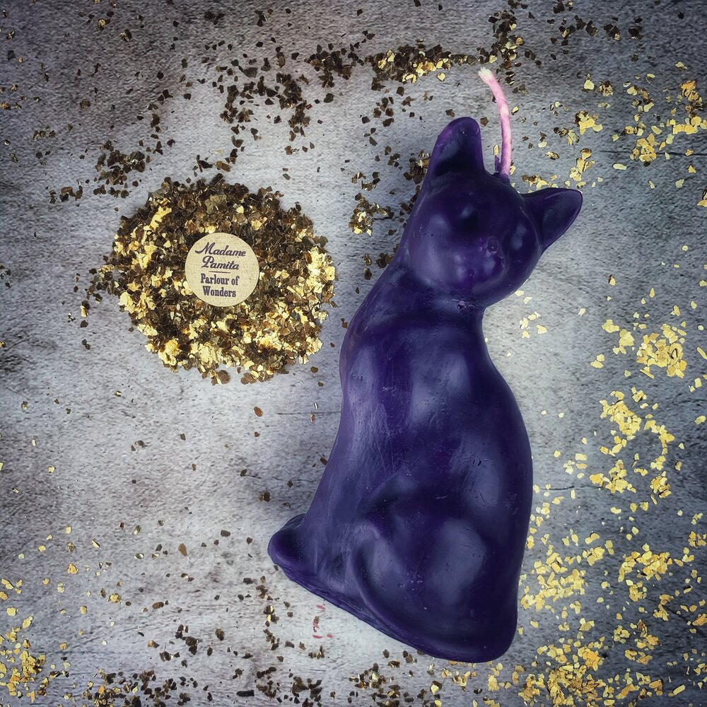 Red beeswax lucky cat spell candle by Parlour of Wonders for fast action and manifestation magic.
