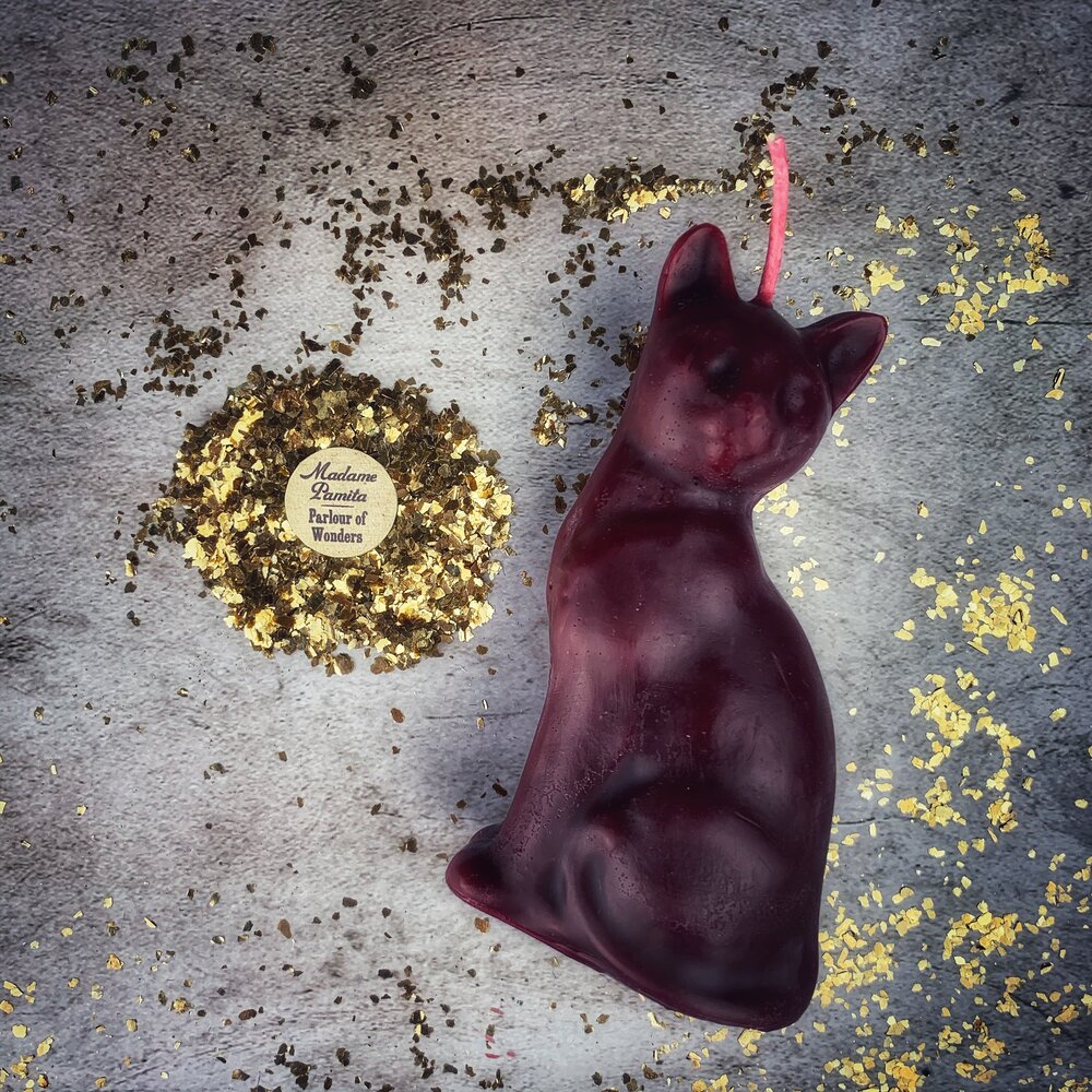 Red beeswax lucky cat spell candle by Parlour of Wonders for fast action and manifestation magic.