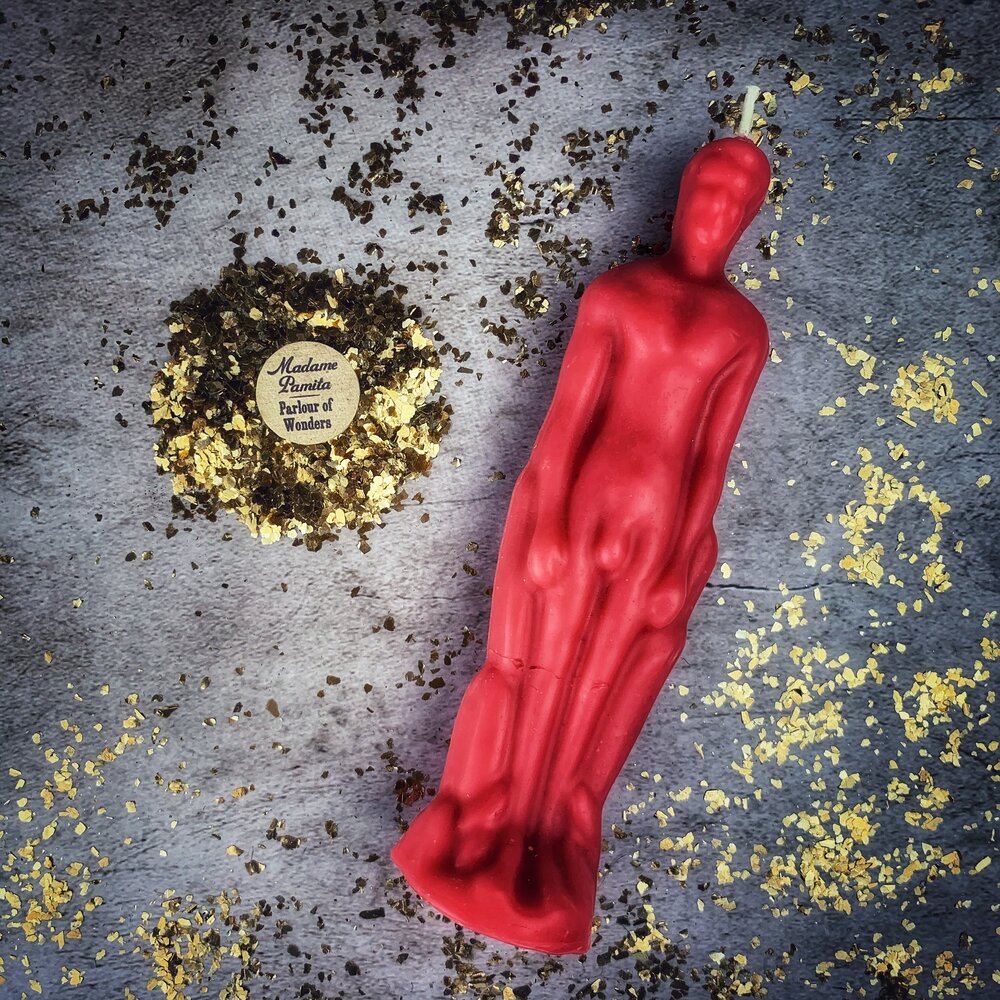 Red beeswax male figural spell candle by Parlour of Wonders for sympathetic magic and personal power rituals.