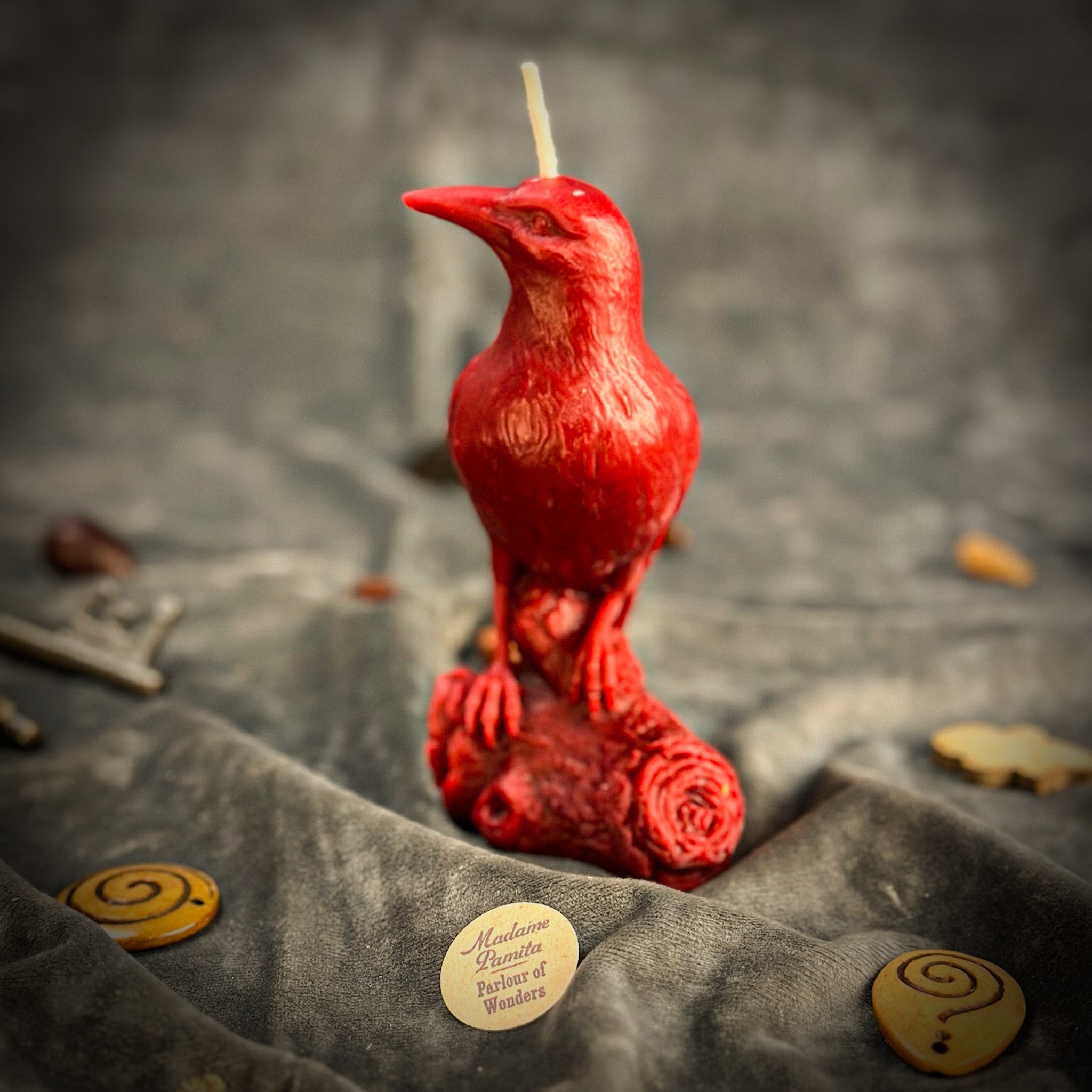 Red beeswax Raven Magic Spell Candle by Parlour of Wonders, used for enhancing intelligence and spirit world connection.