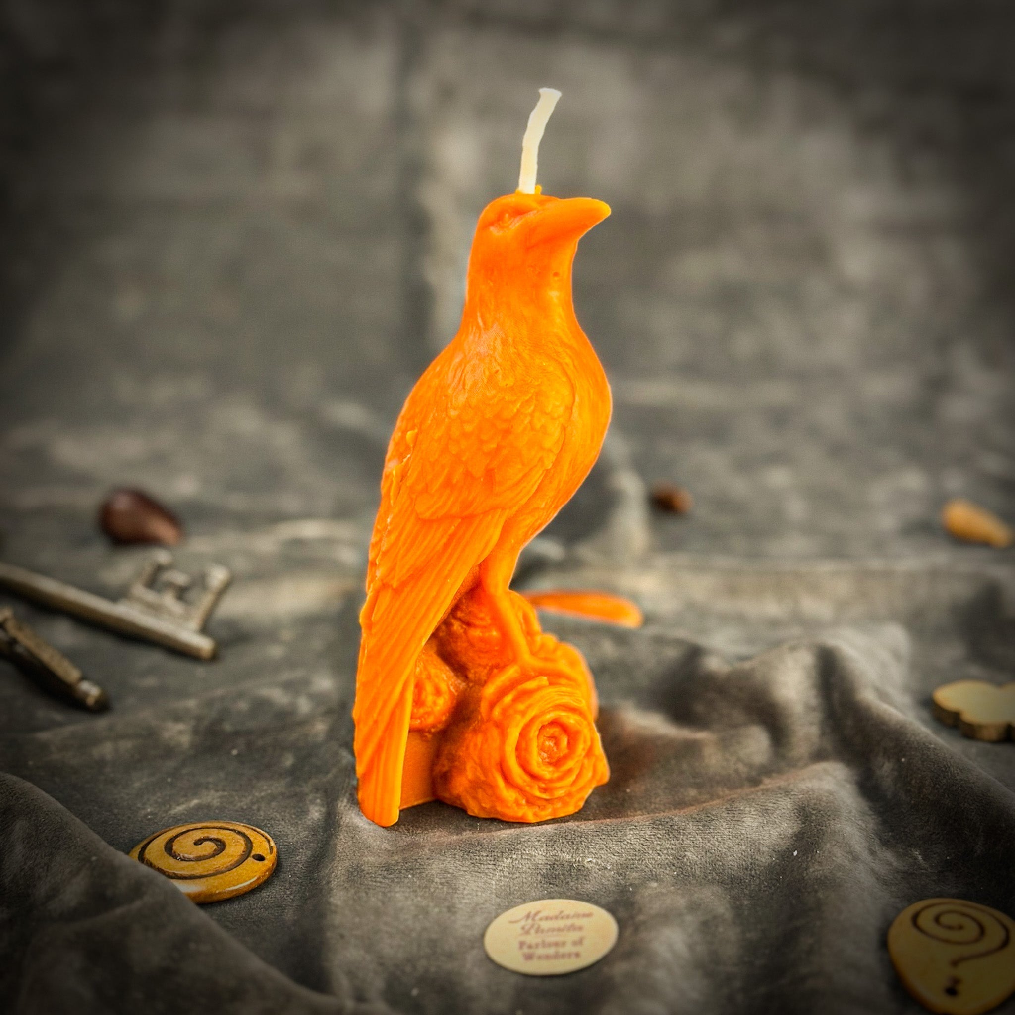 Red beeswax Raven Magic Spell Candle by Parlour of Wonders, symbolizing intelligence and spirit world connection.