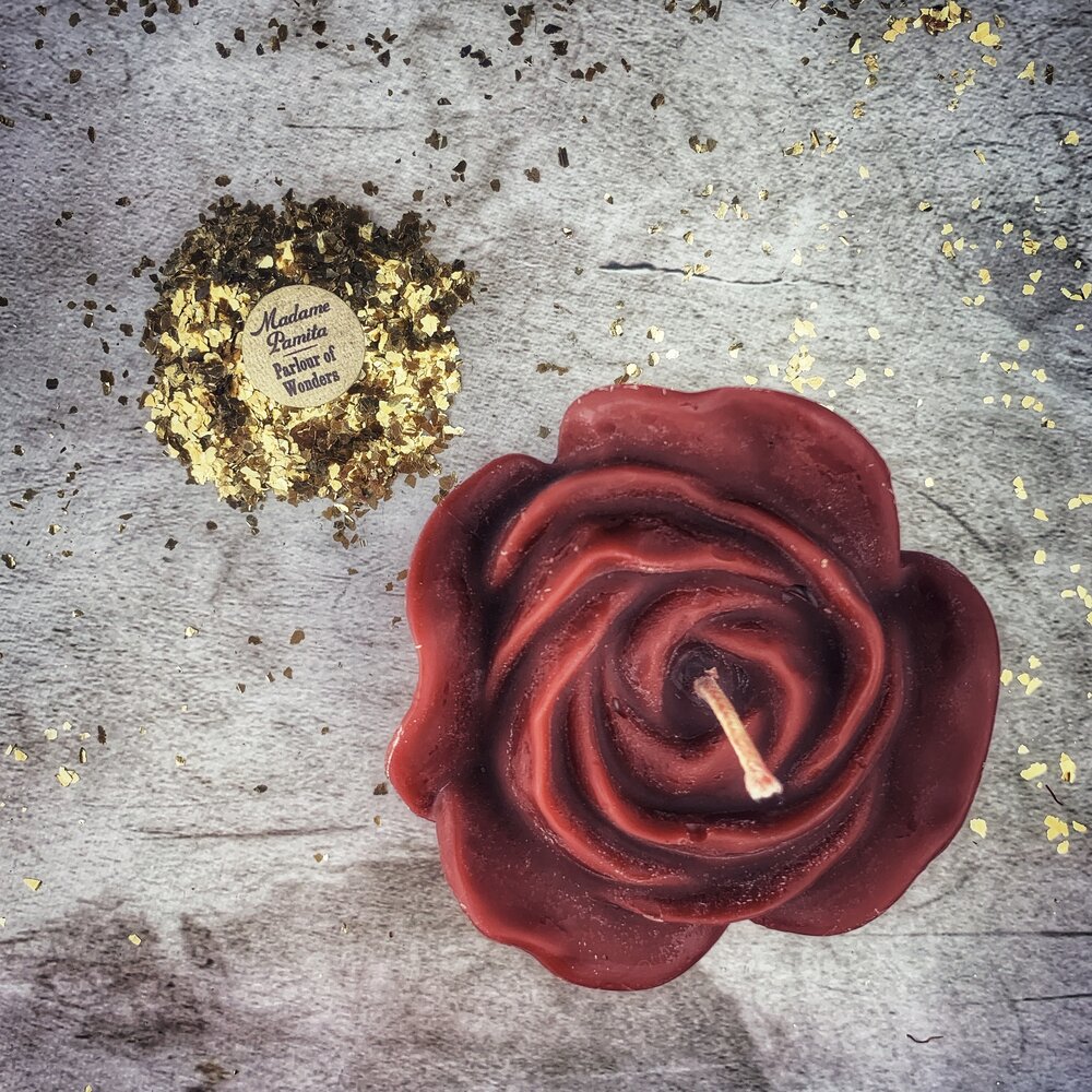 Red beeswax candle with rose design by Parlour of Wonders, used for love and soul mate magic spells.