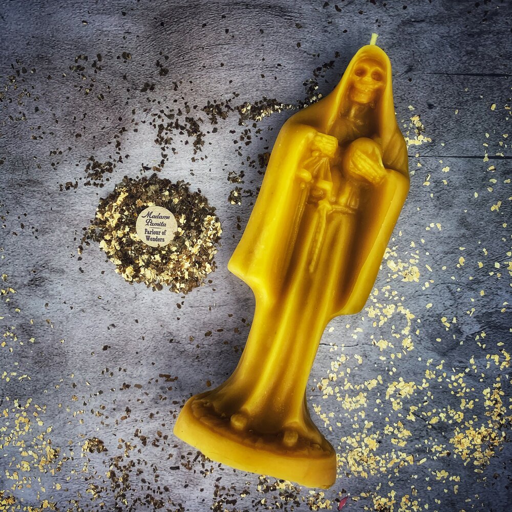 Red beeswax Santa Muerte spell candle by Parlour of Wonders, featuring sacred folk saint imagery for devotion and protection magic.