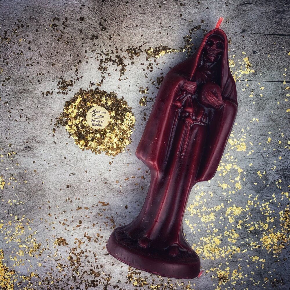 Red beeswax Santa Muerte spell candle from Parlour of Wonders for devotion and protection magic, featuring sacred folk saint imagery.