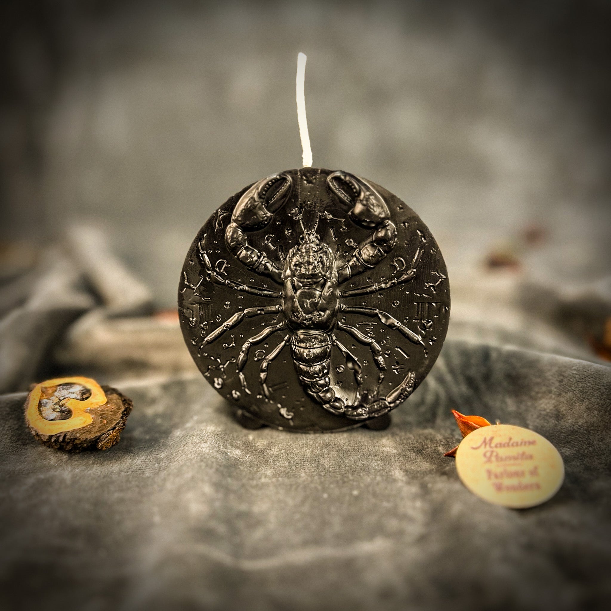 Red beeswax candle featuring a scorpion design, symbolizing transformation, power, and intuition for Scorpio zodiac spell.