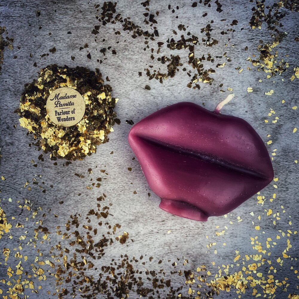 Red beeswax candle shaped like lips, with "Talk to Me" inscription, used for communication and passion magic spells.