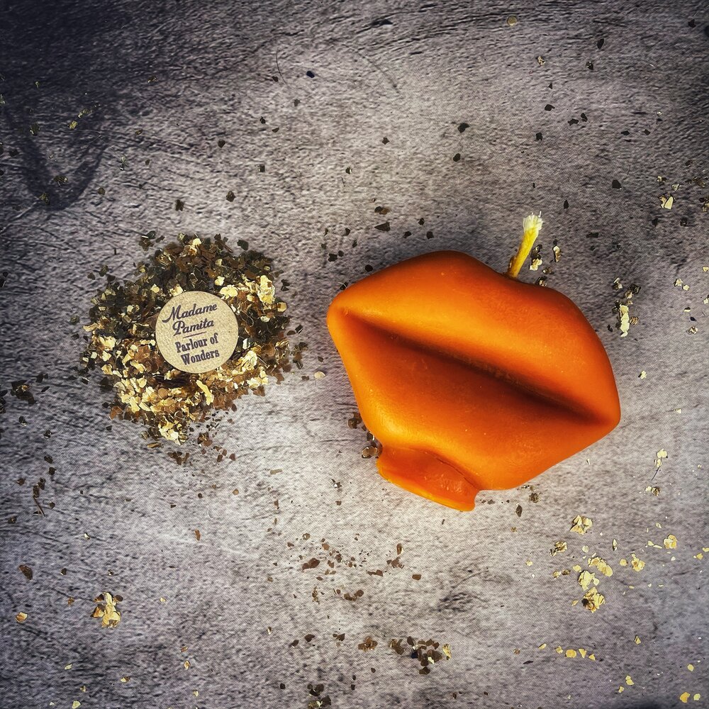 Red beeswax candle shaped like lips, used for communication and passion magic, by Parlour of Wonders.