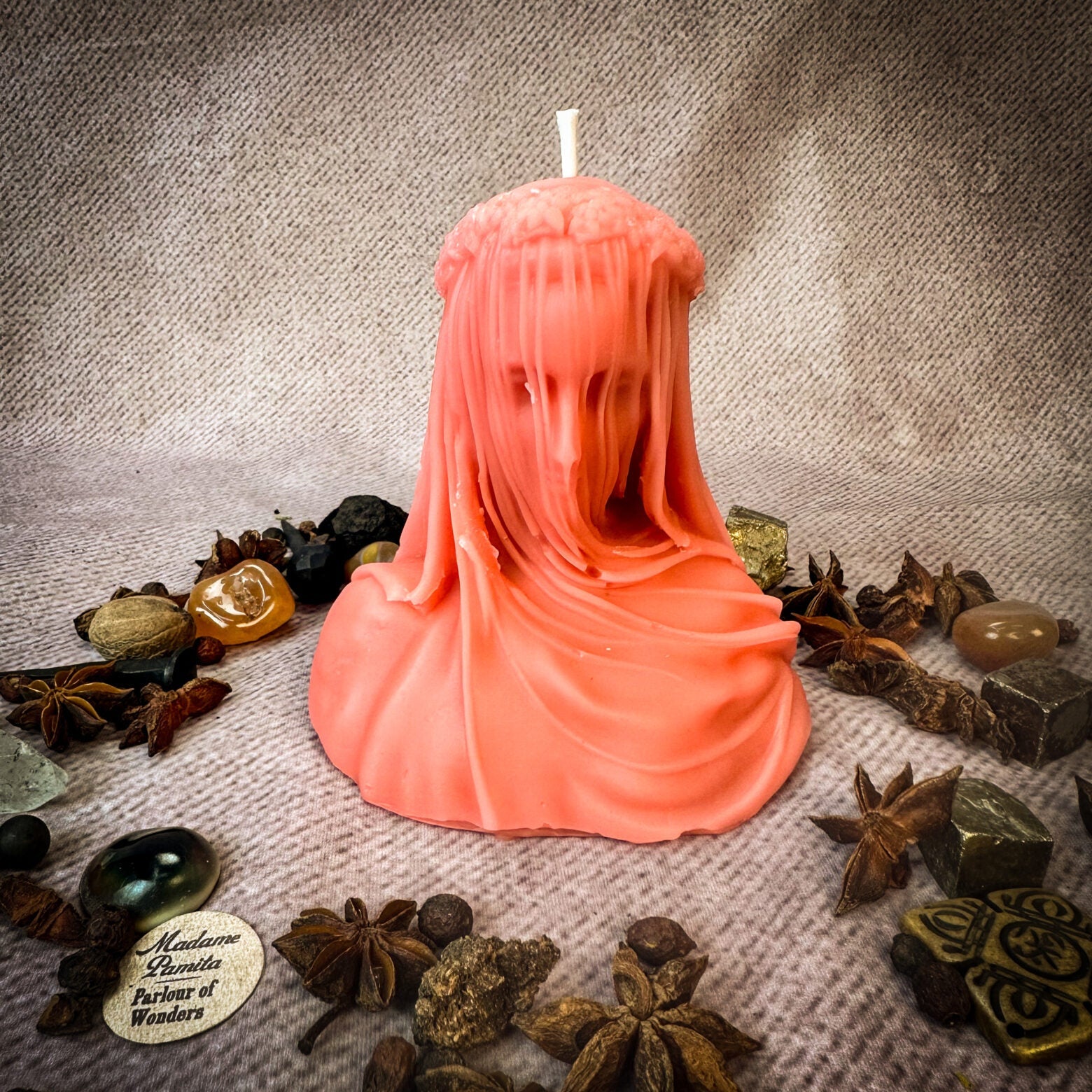 Red beeswax candle from Parlour of Wonders with intricate wax veil, symbolizing secrets, truth, and privacy protection.