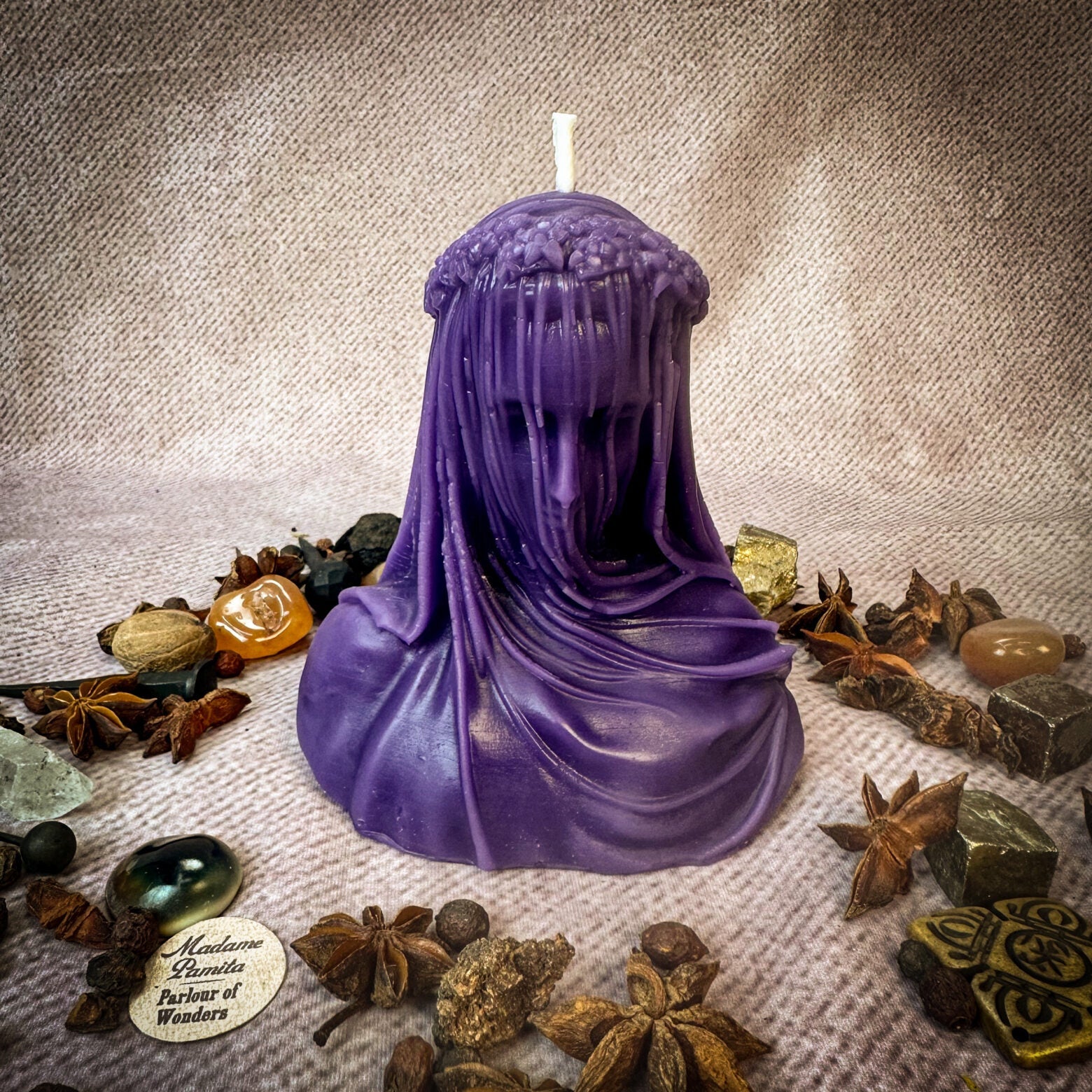Red beeswax candle from Parlour of Wonders with intricate sealing wax design, symbolizing truth, secrets, and privacy protection.