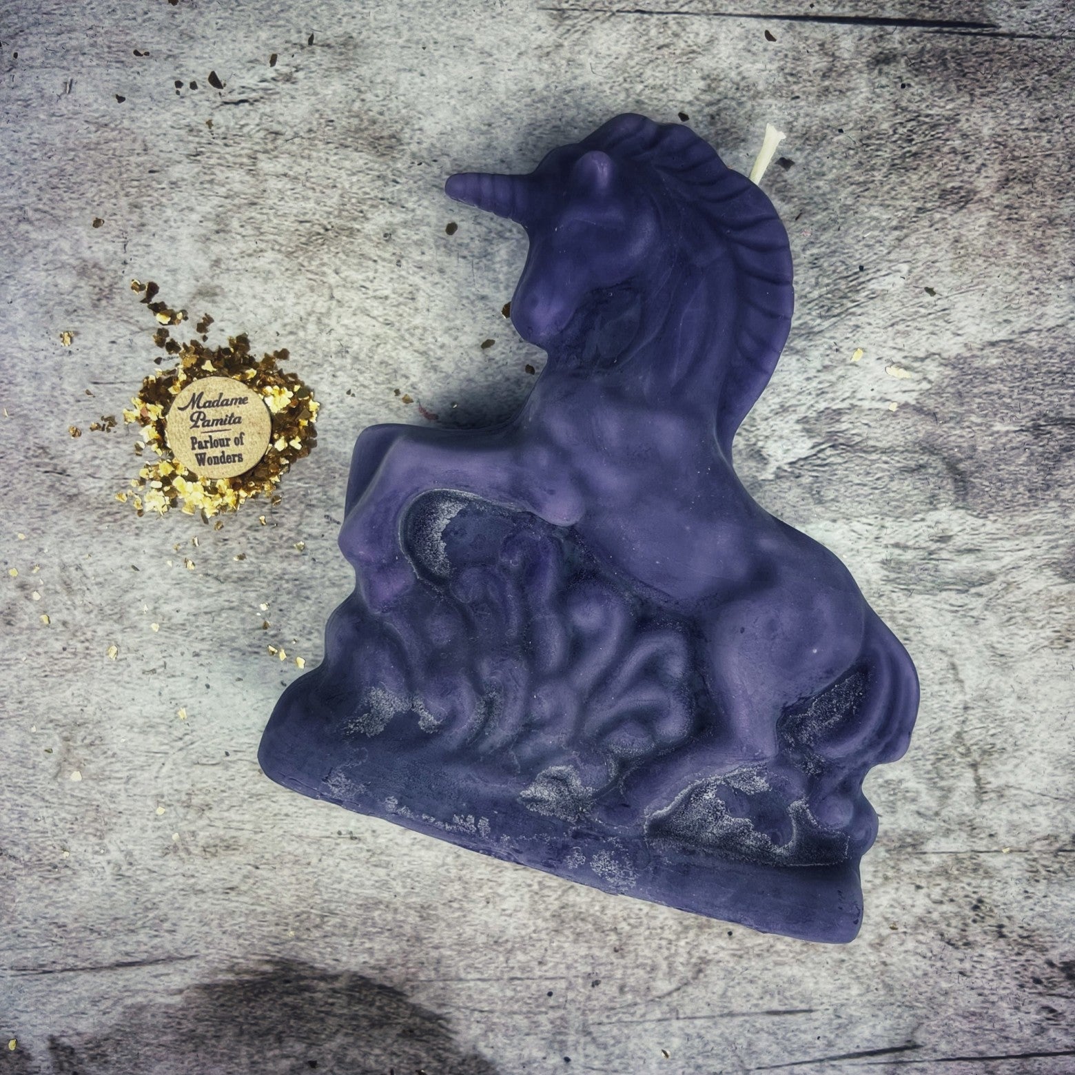 White beeswax unicorn spell candle by Parlour of Wonders for manifestation, wishes, and magic, featuring intricate enchanted unicorn design.